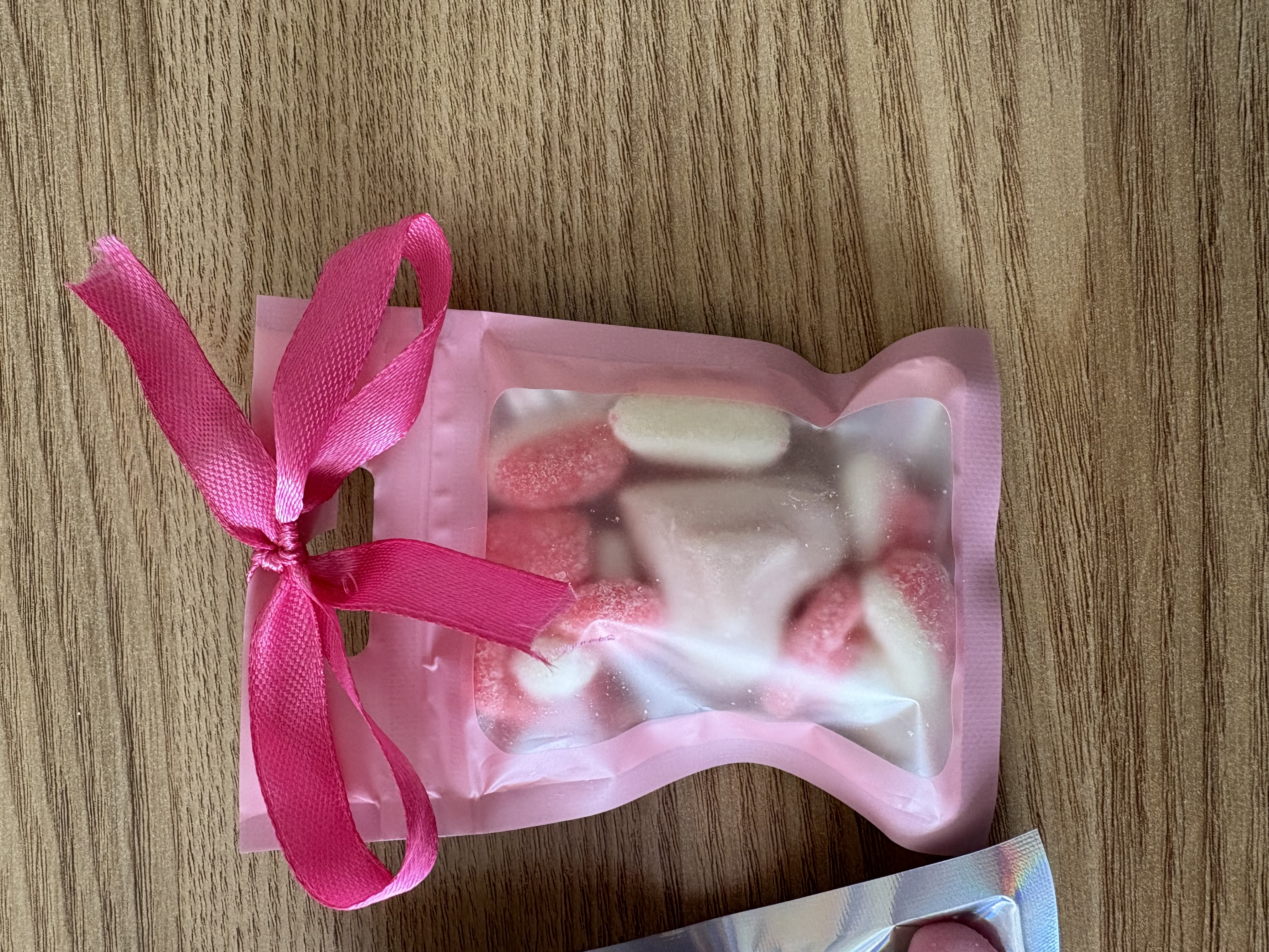 Mini sweet pouches with sweets and ribbon to the top