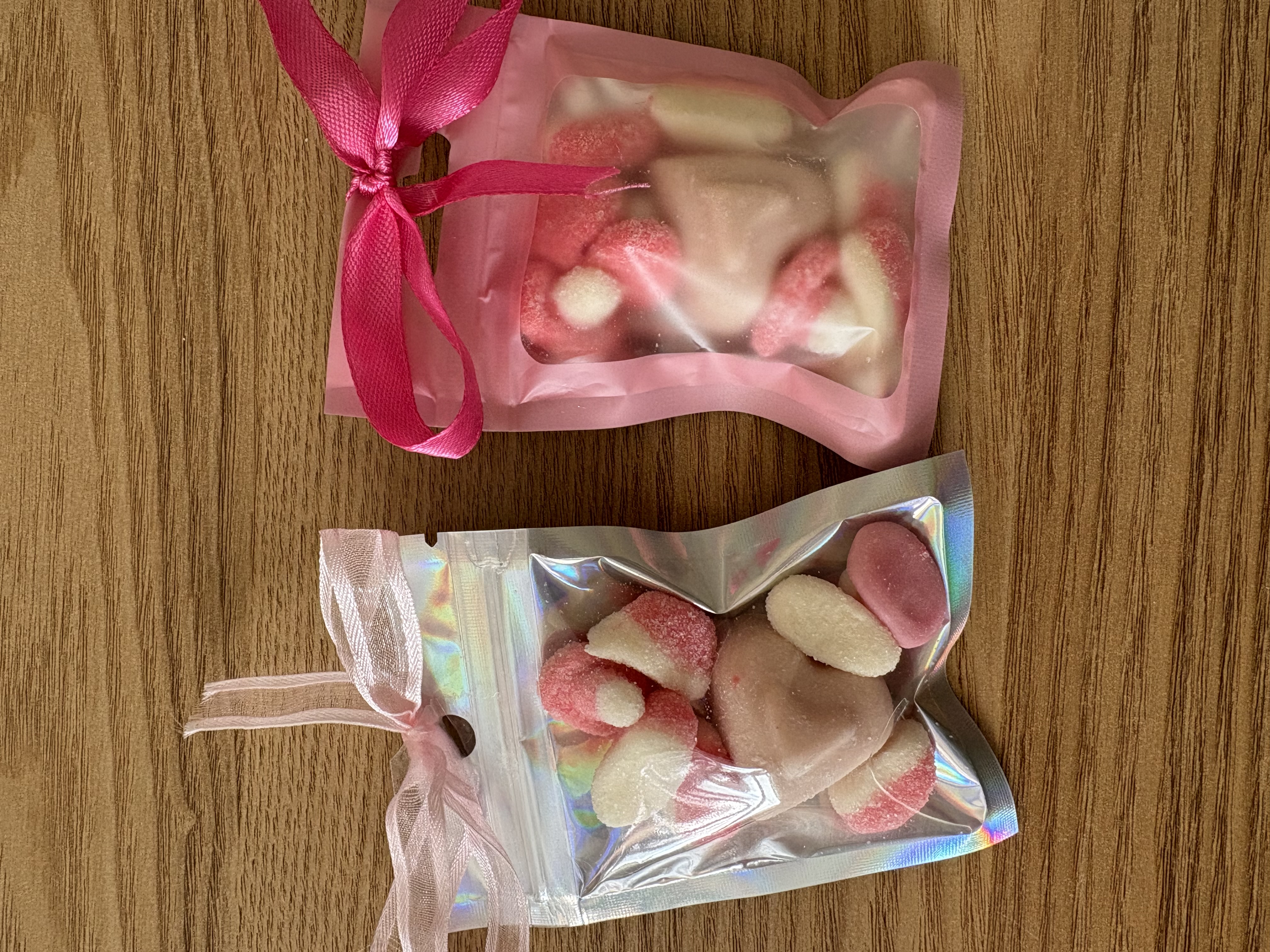 Mini sweet pouches with sweets and ribbon to the top
