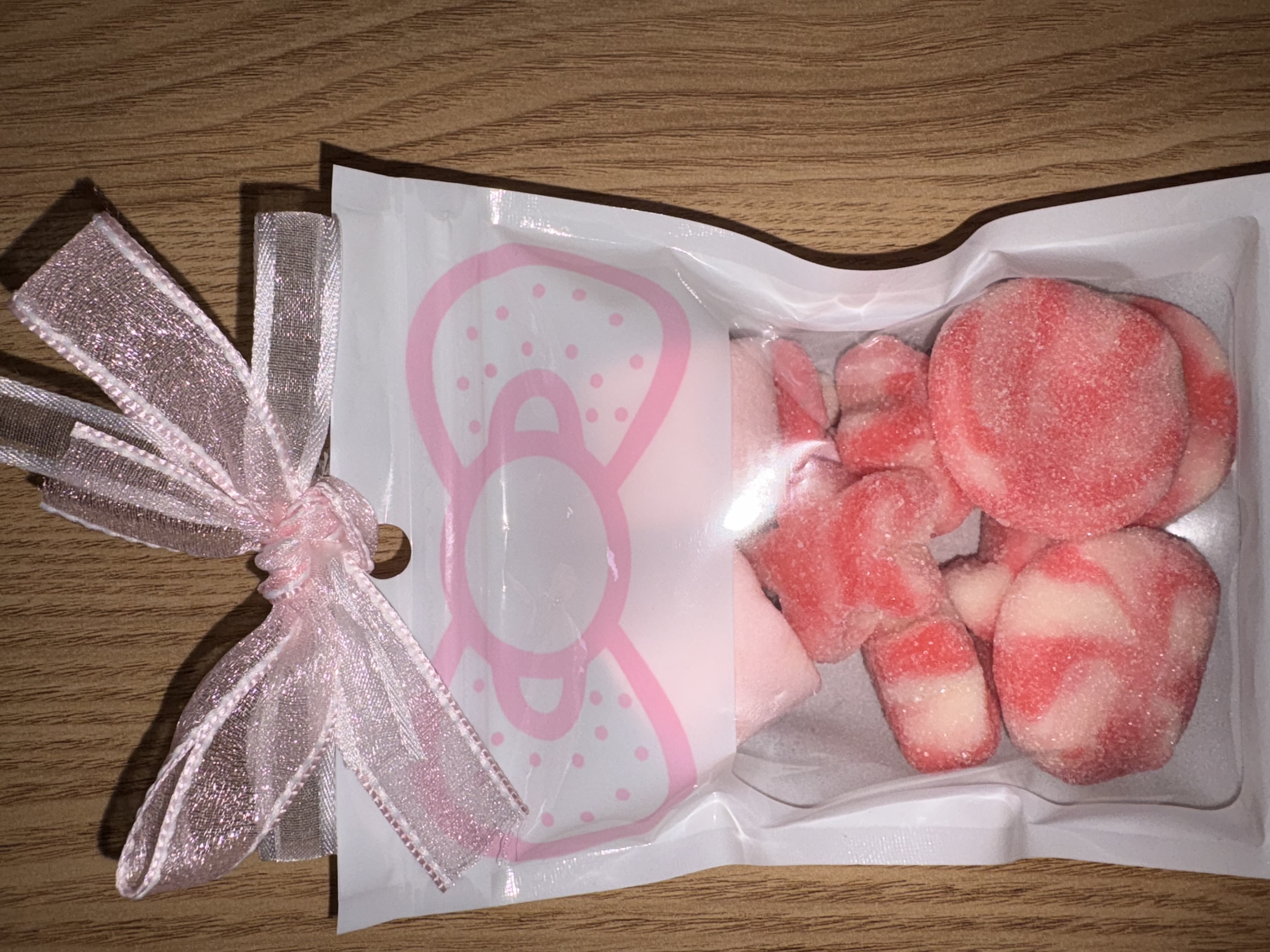 White sweet pouch with large pink bow to the top finished with two tone organza ribbon