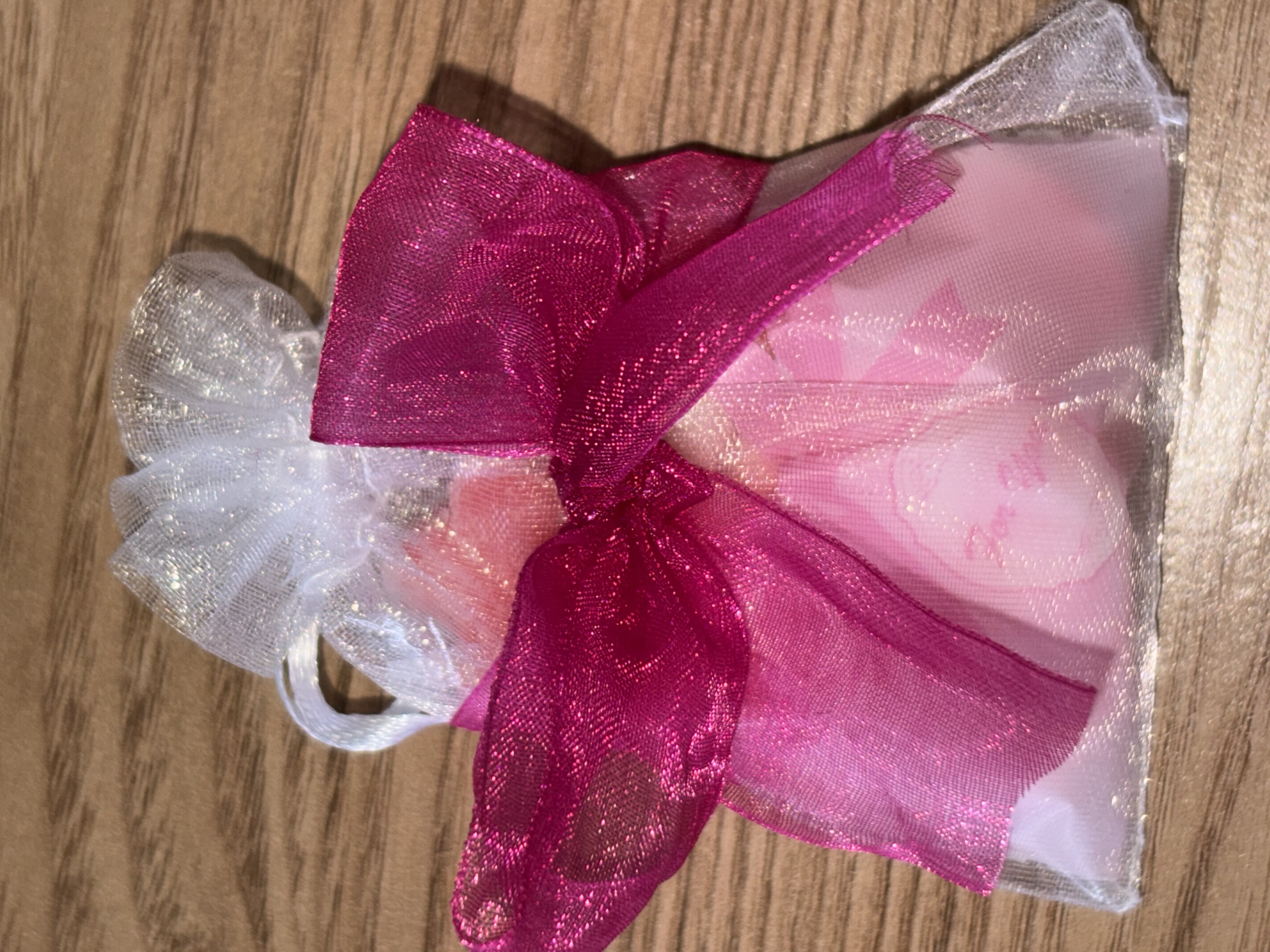Cute organza bag with small bag of sweets with beautiful organza ribbon to the front