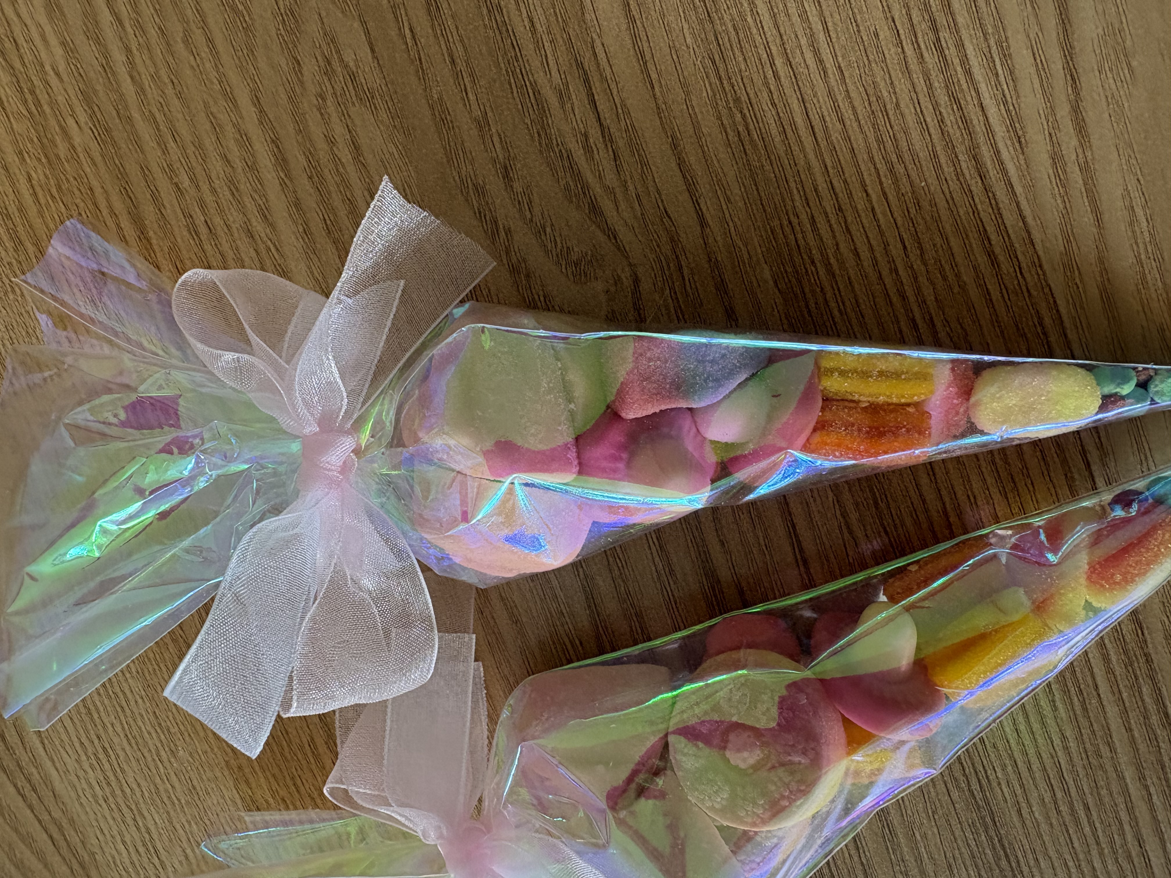 Iredescent sweetcones complete with a variety of tasty sweets and finished with beautiful organza ribbon