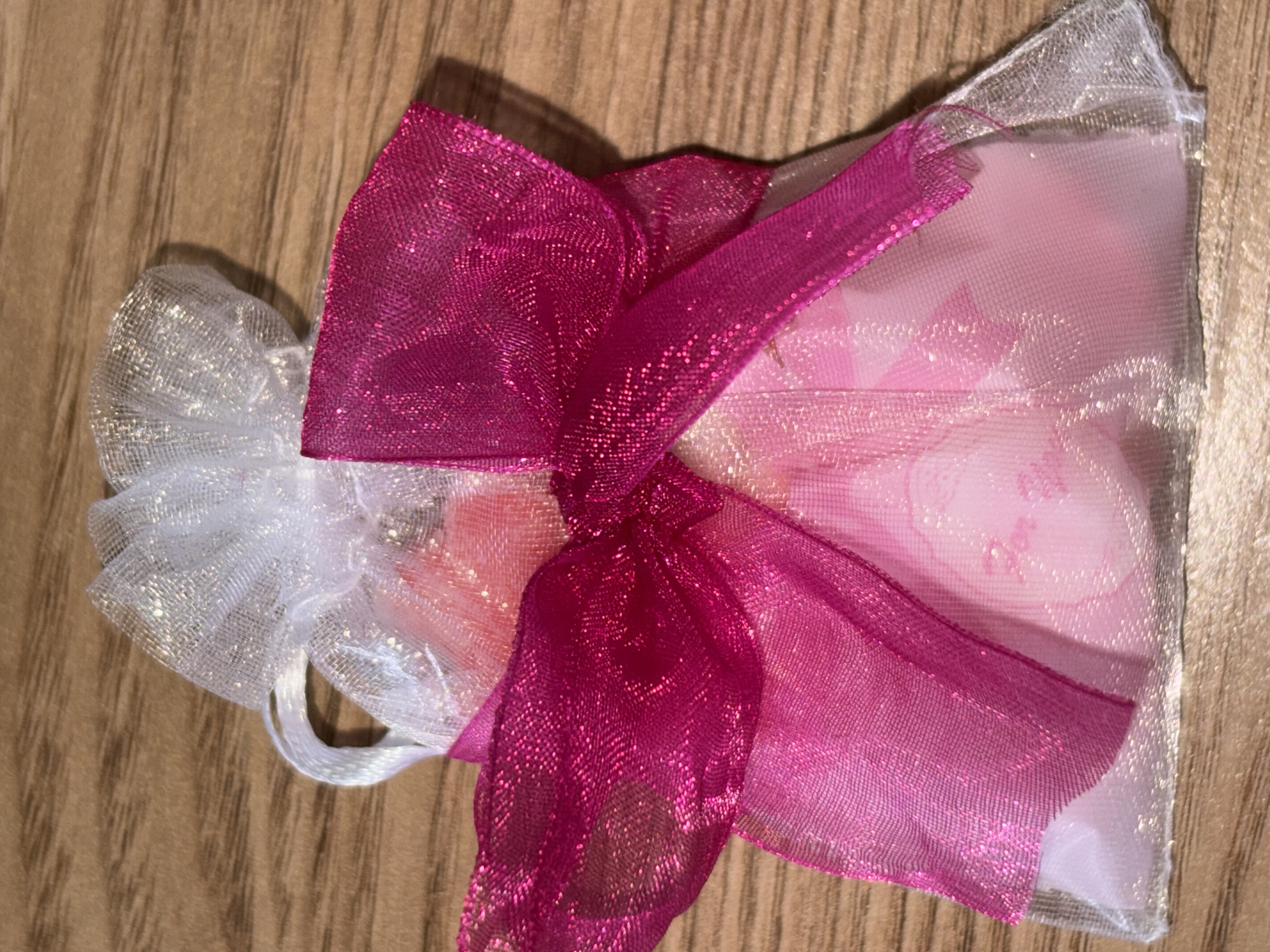 Cute organza bag with small bag of sweets with beautiful organza ribbon to the front