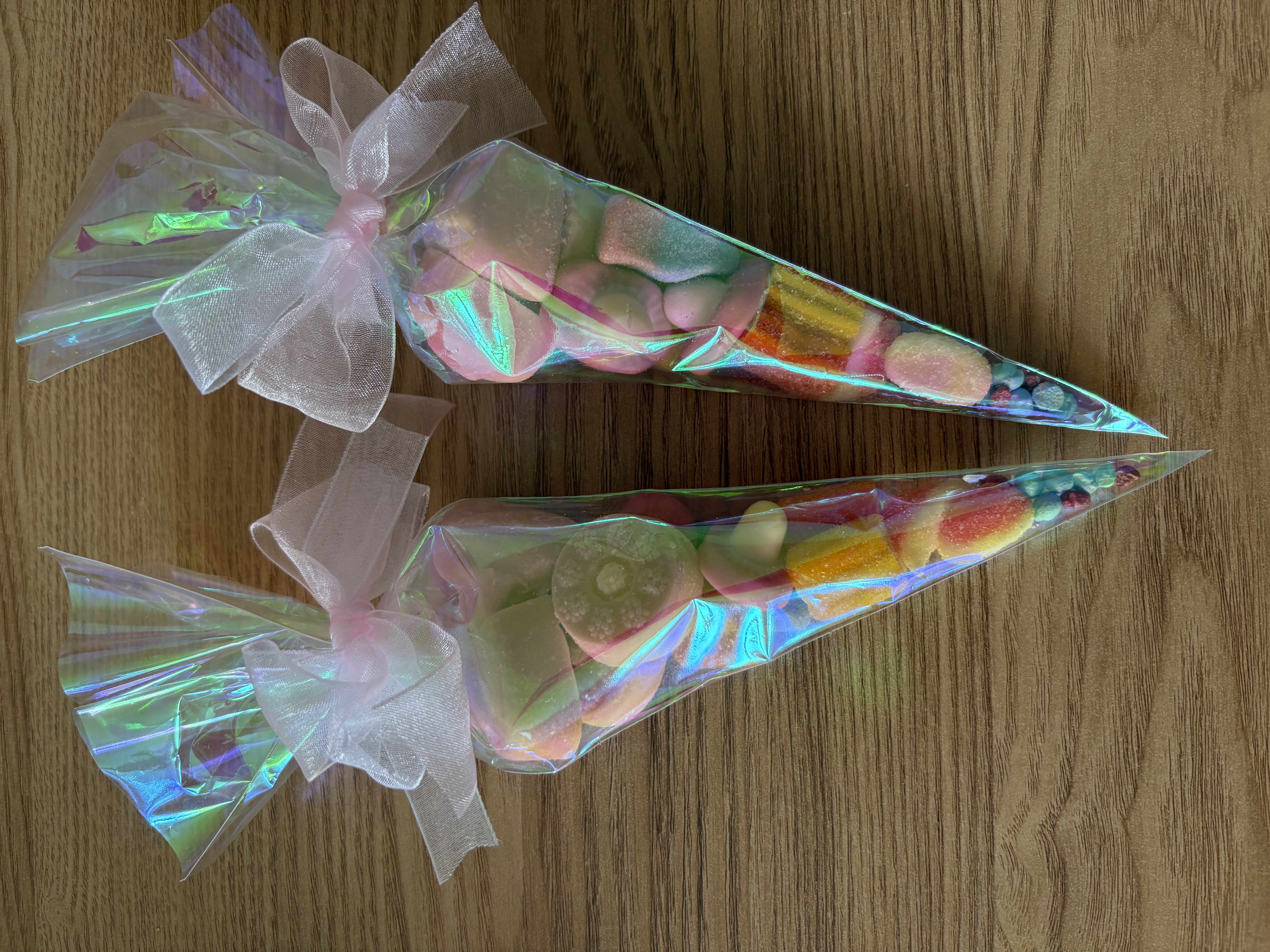 Iredescent sweetcones complete with a variety of tasty sweets and finished with beautiful organza ribbon