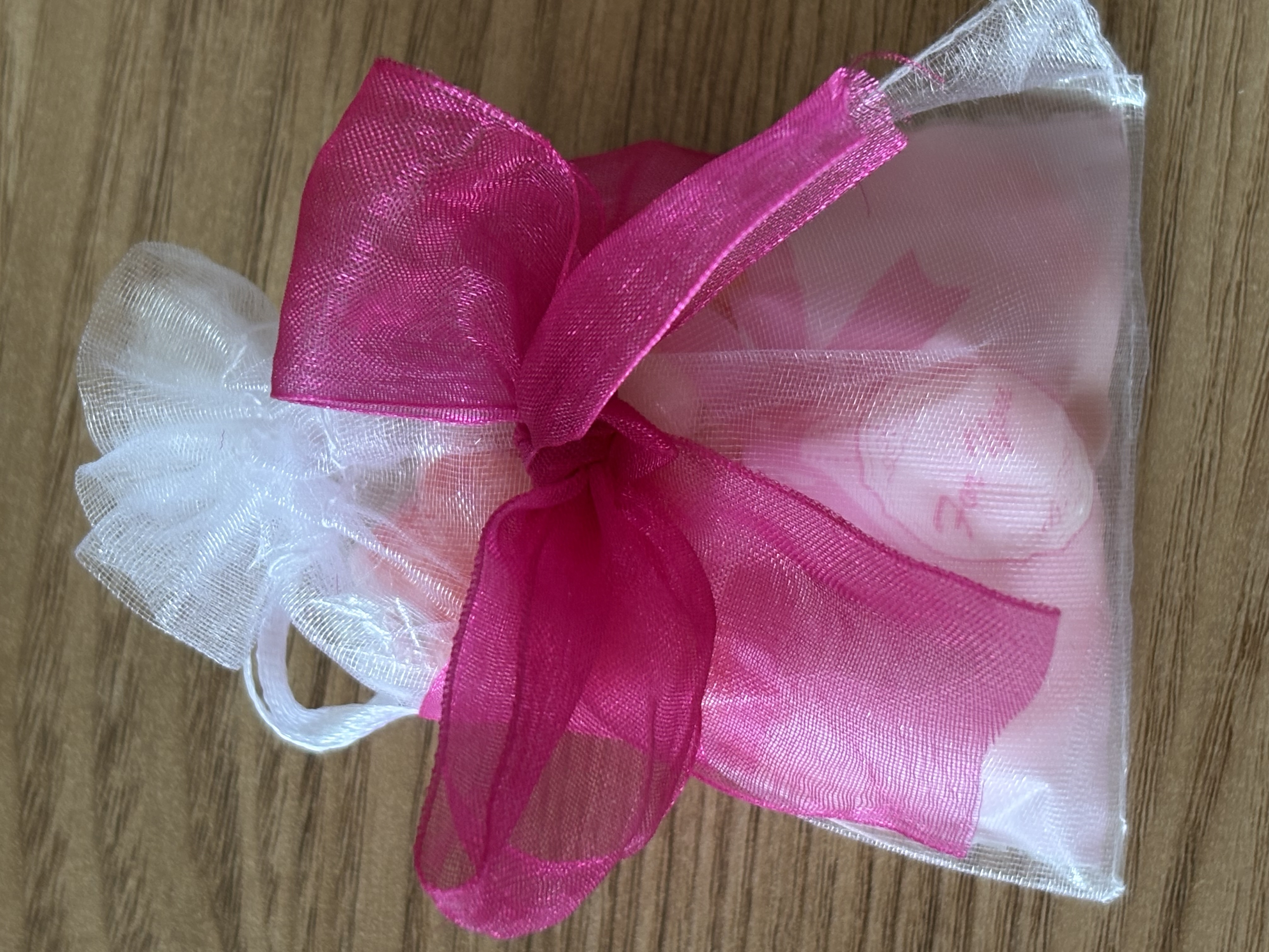 Cute organza bag with small bag of sweets with beautiful organza ribbon to the front