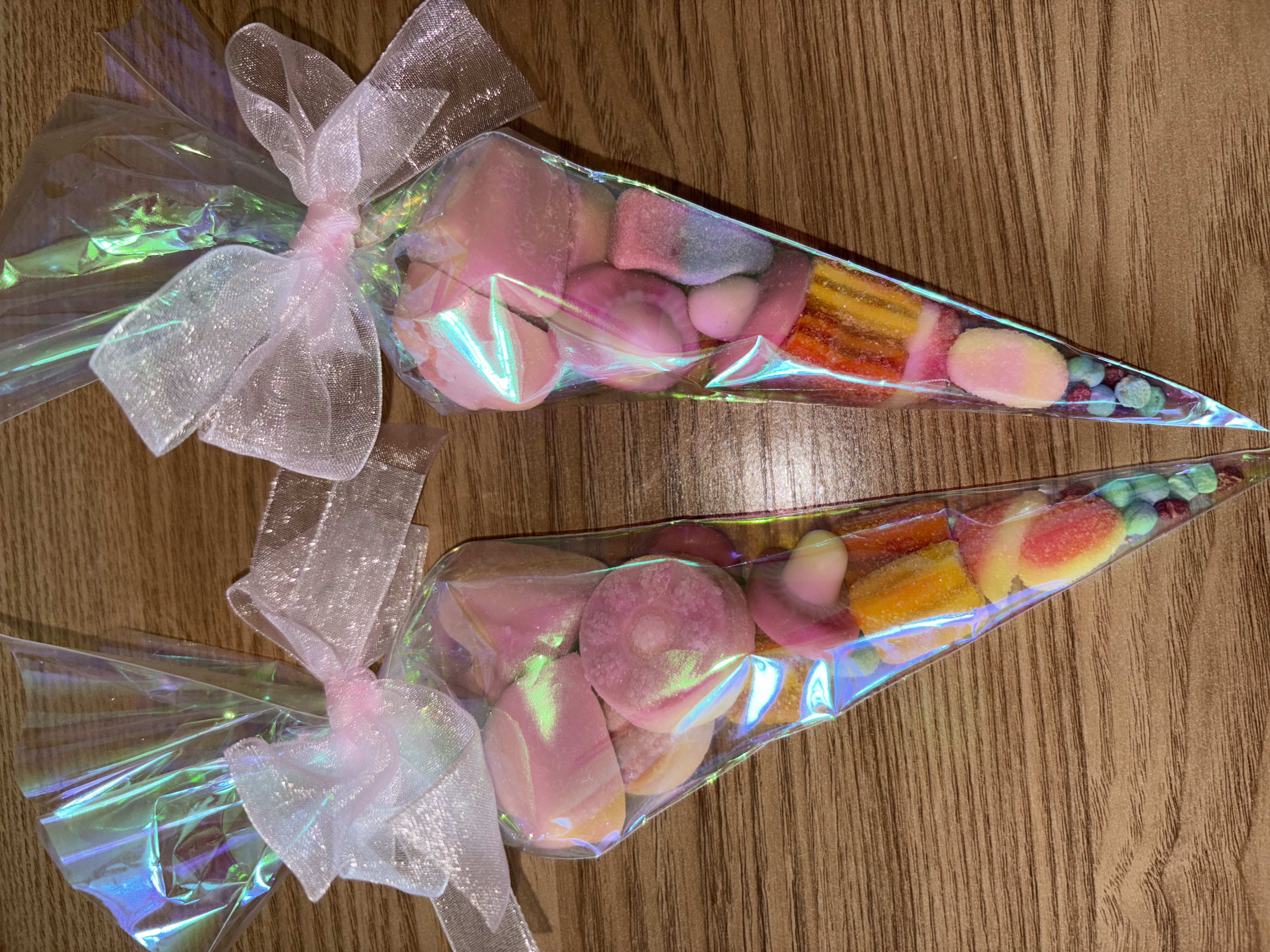 Iredescent sweetcones complete with a variety of tasty sweets and finished with beautiful organza ribbon