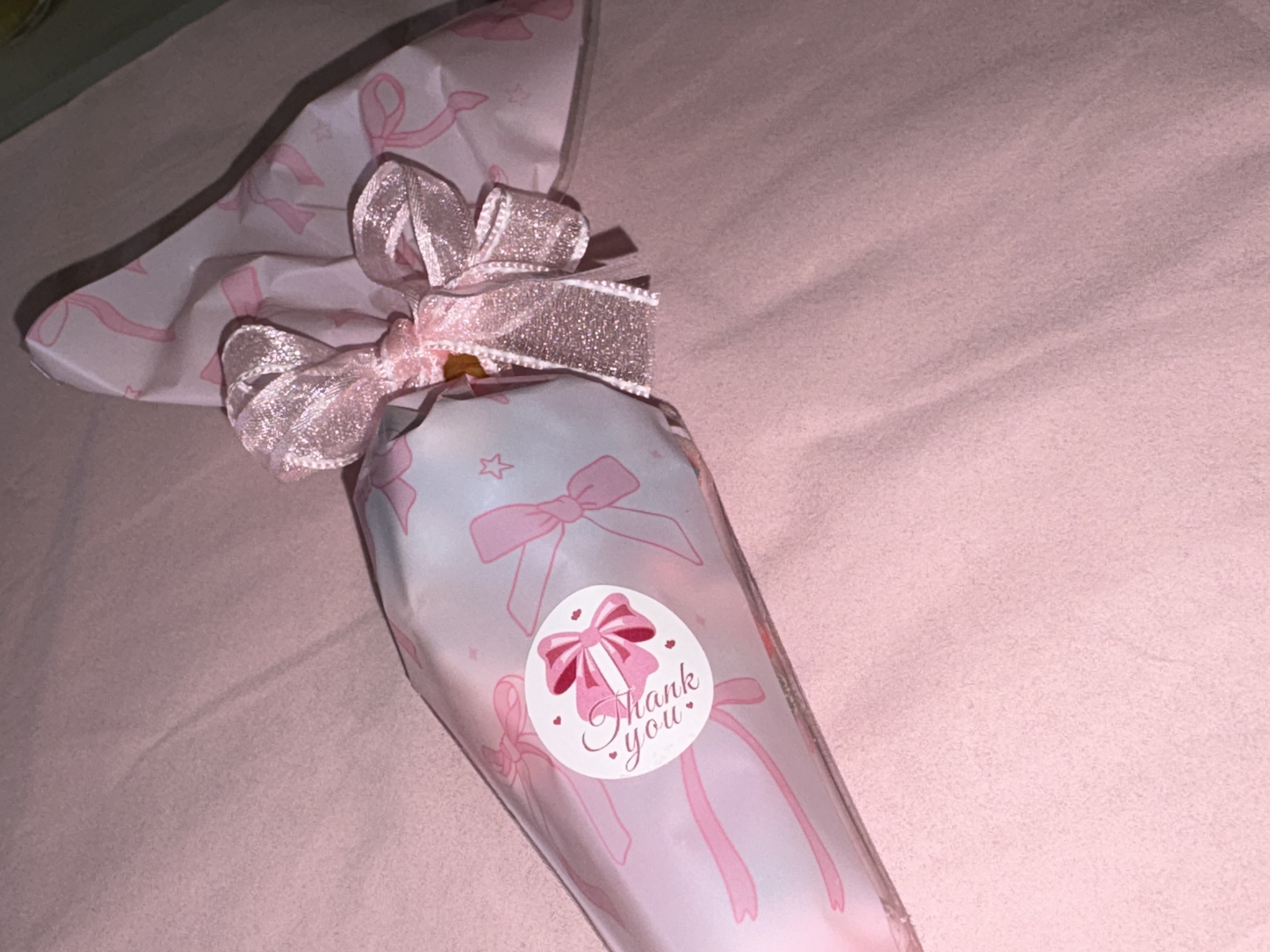 Beautiful pink bow design complete with a variety of sweets and two tone organza ribbon