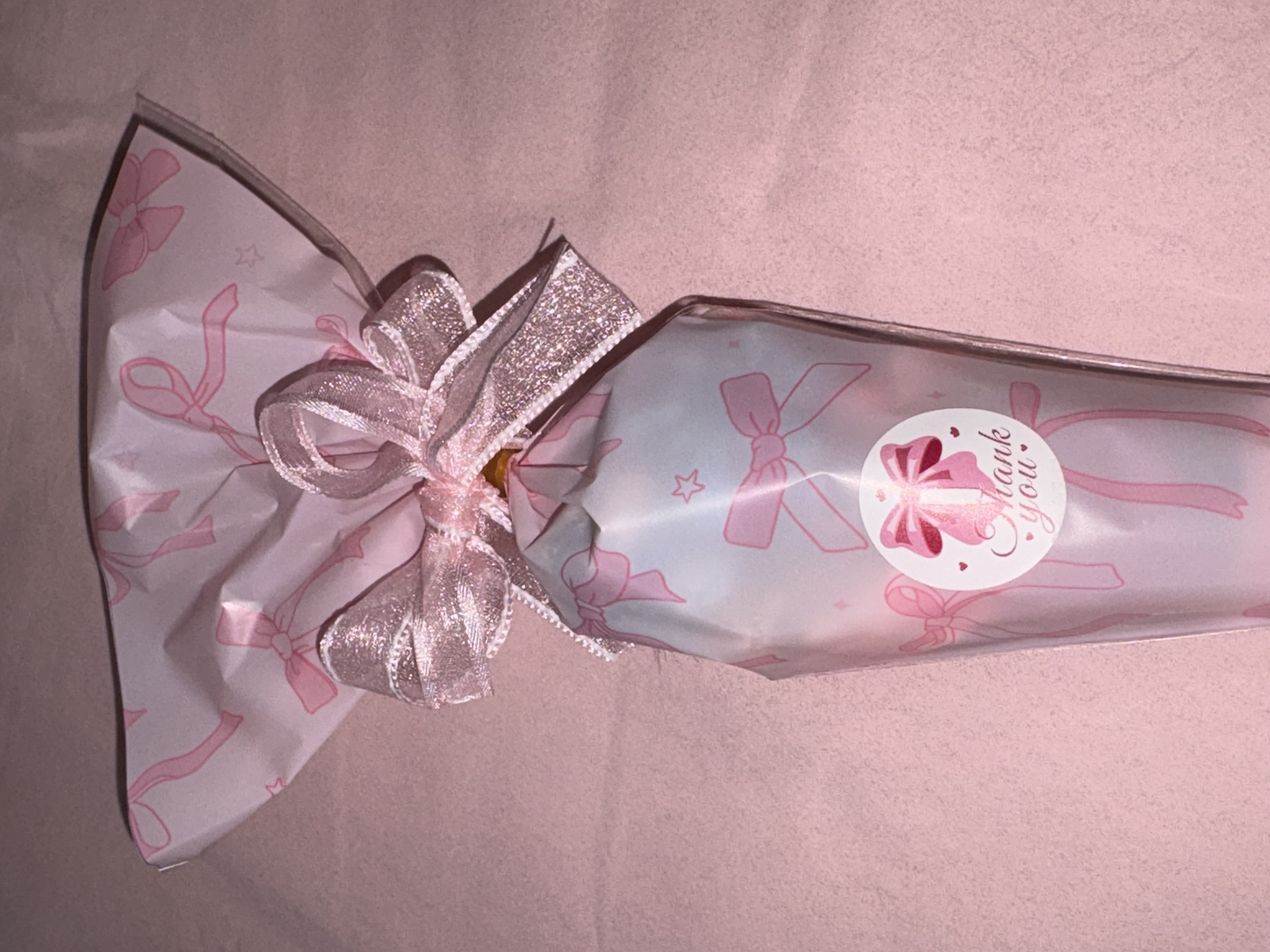 Beautiful pink bow design complete with a variety of sweets and two tone organza ribbon