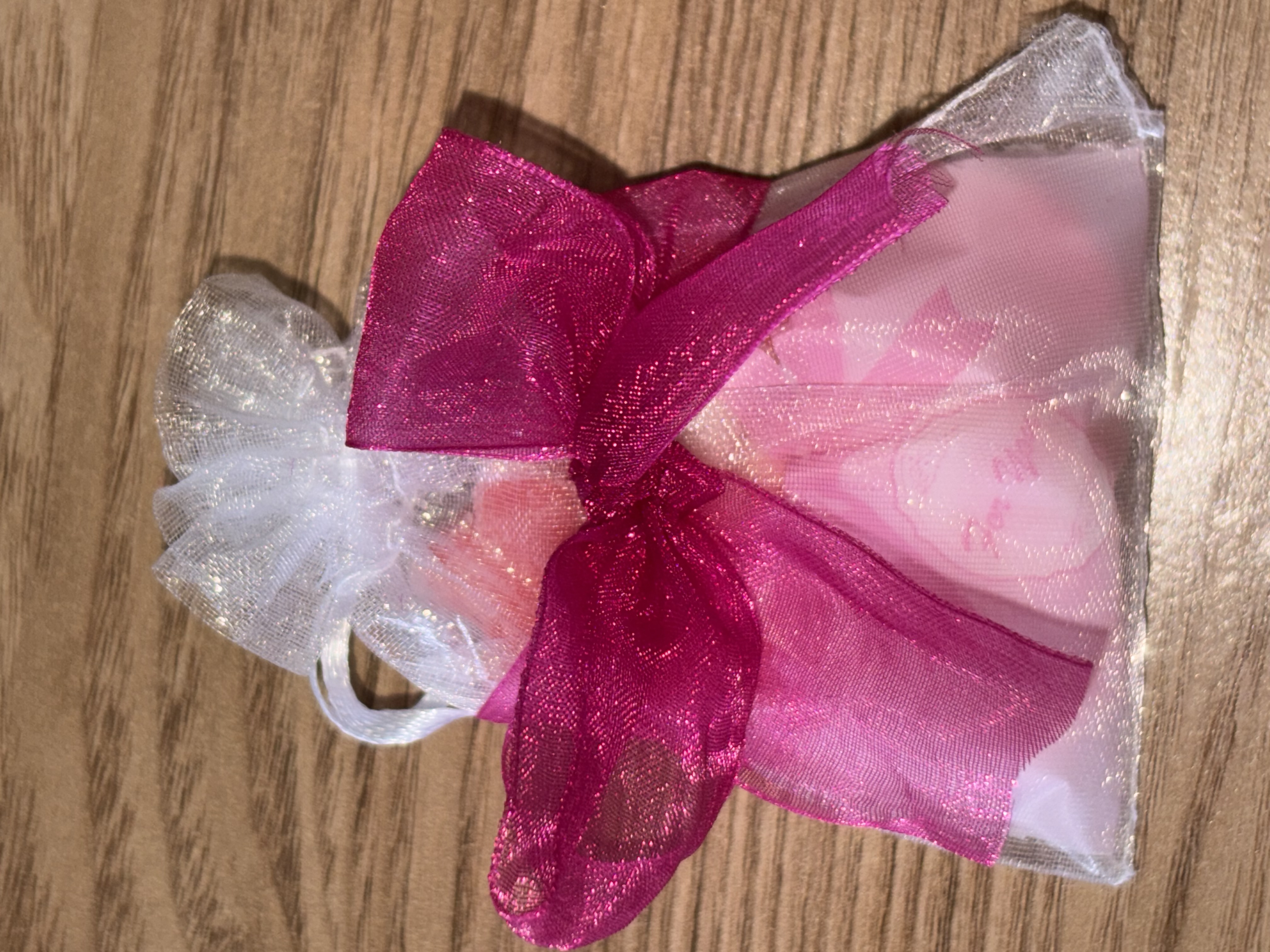 Cute organza bag with small bag of sweets with beautiful organza ribbon to the front