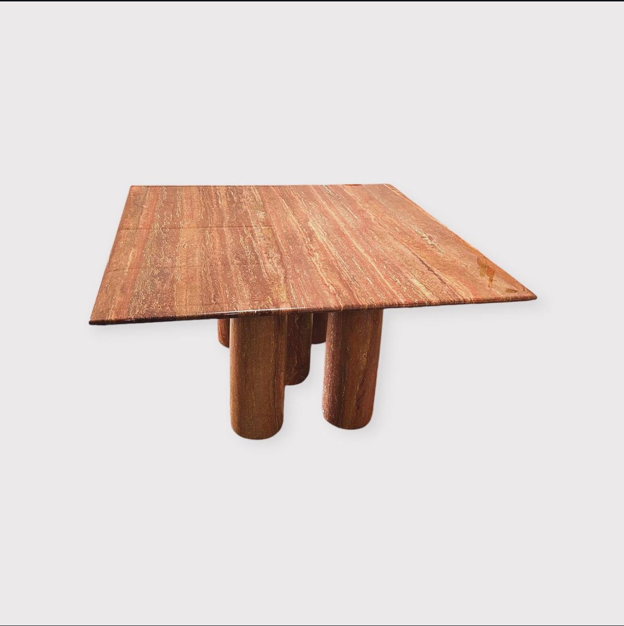 Mario Bellini 'll Colonato' Dining table, red travertine, Italy, 1970s.
