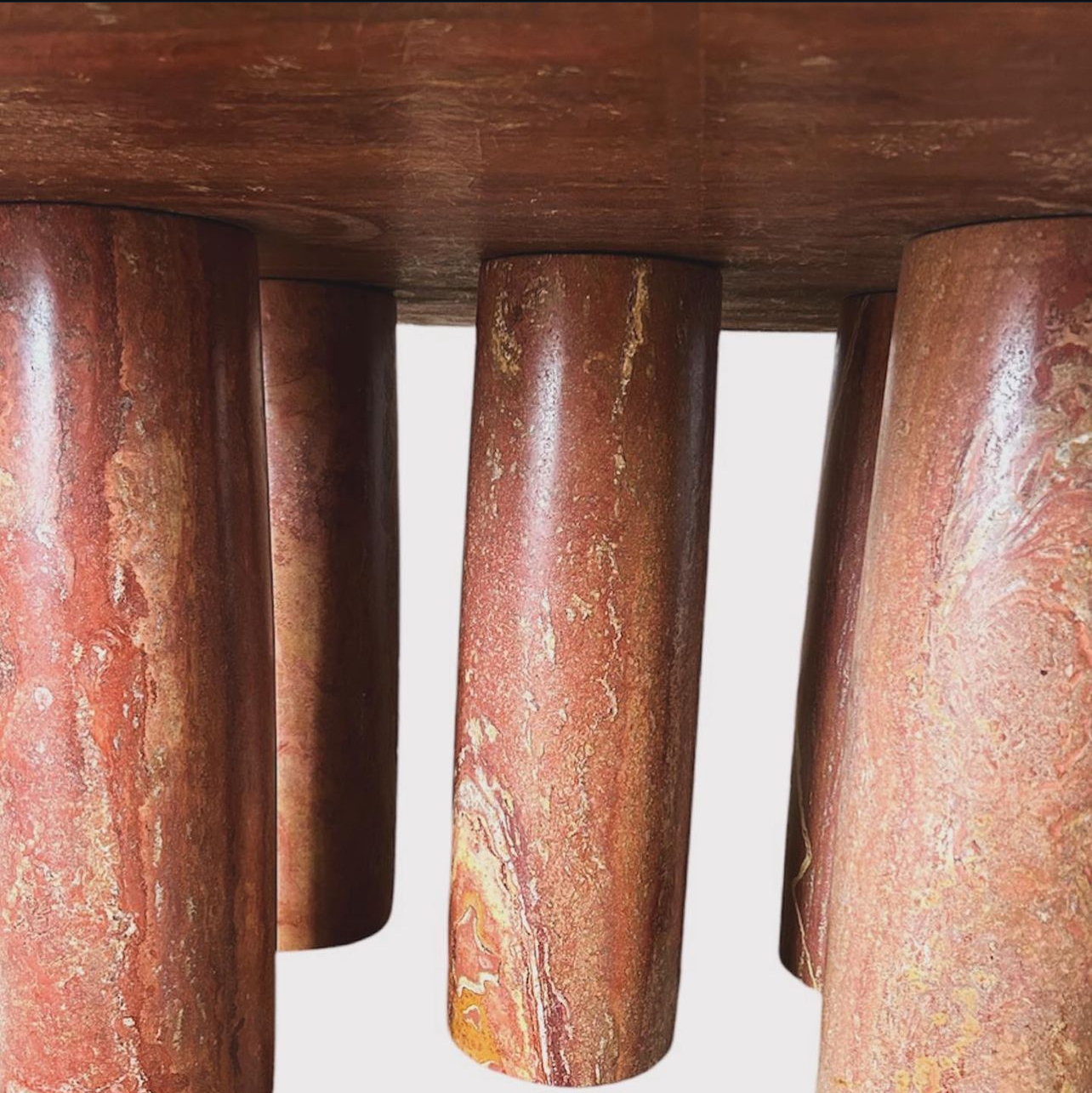Mario Bellini 'll Colonato' Dining table, red travertine, Italy, 1970s.