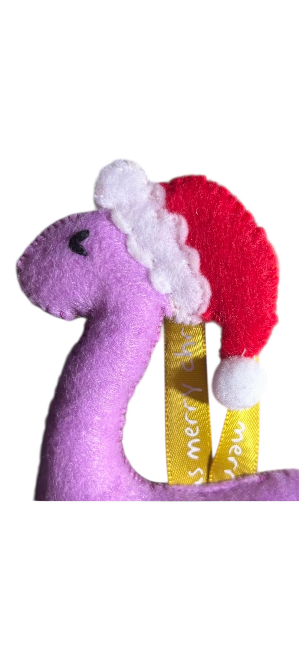 Handmade felt Christmas Dinosaur with Santa hat on.