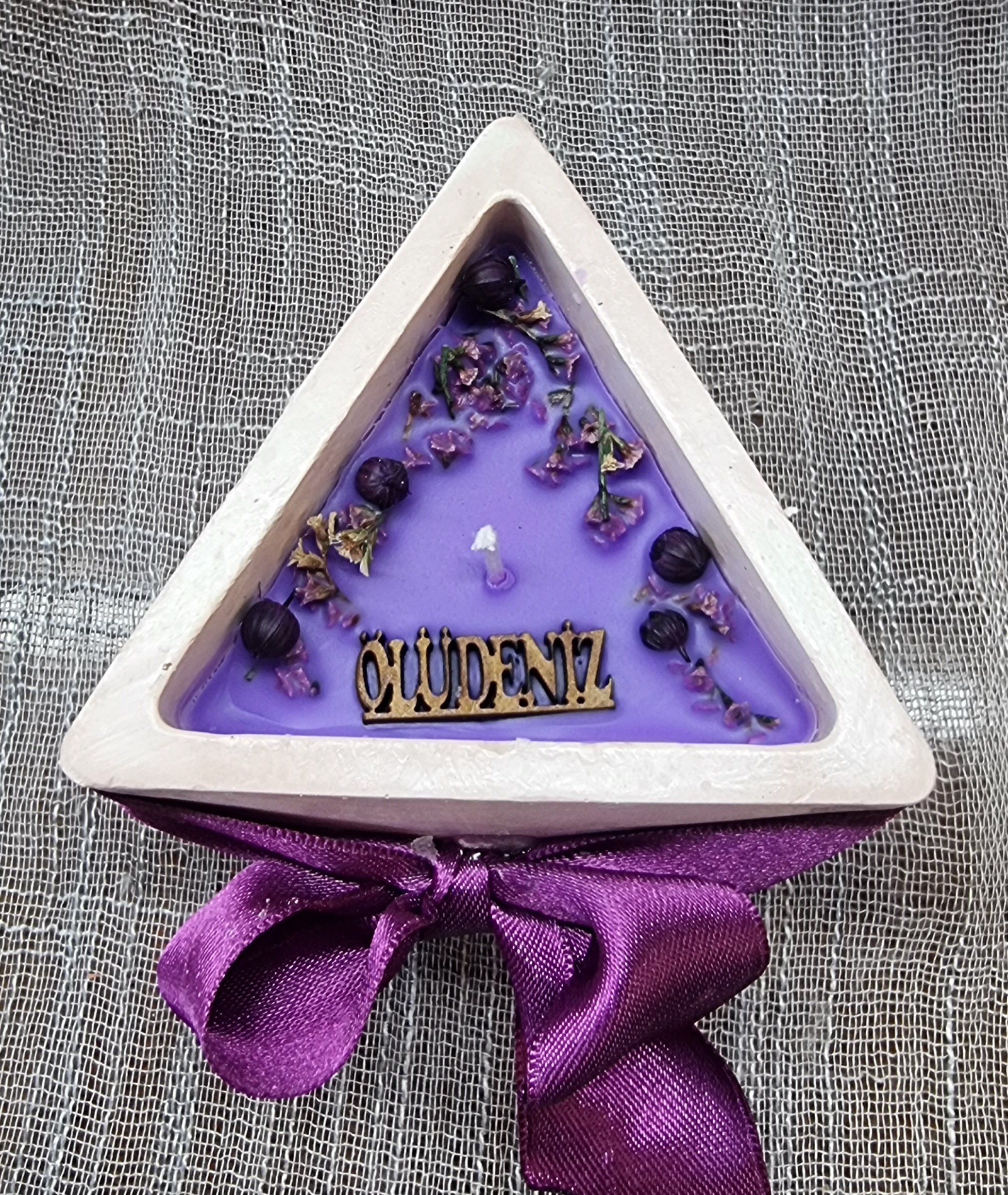 Purple wax in a triangular container (lavender scented)