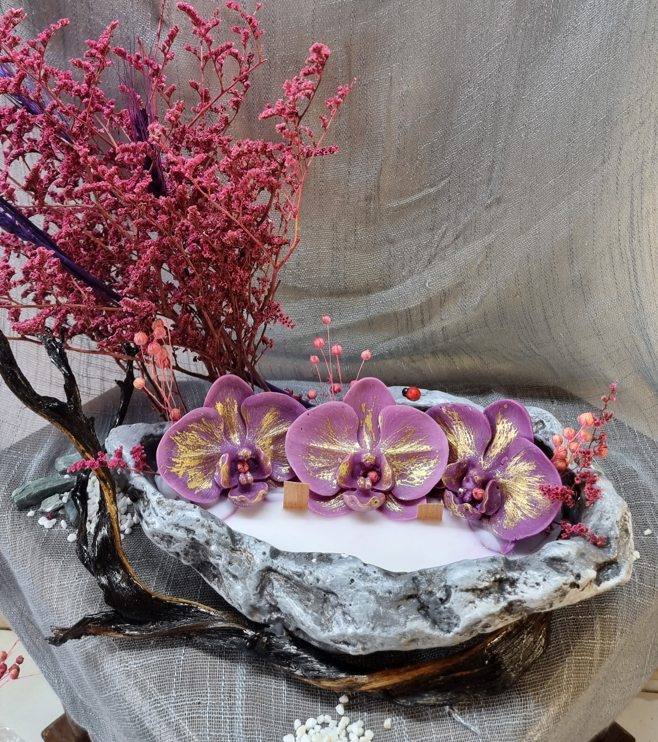 King-size candle with dark-pink wax orchids 