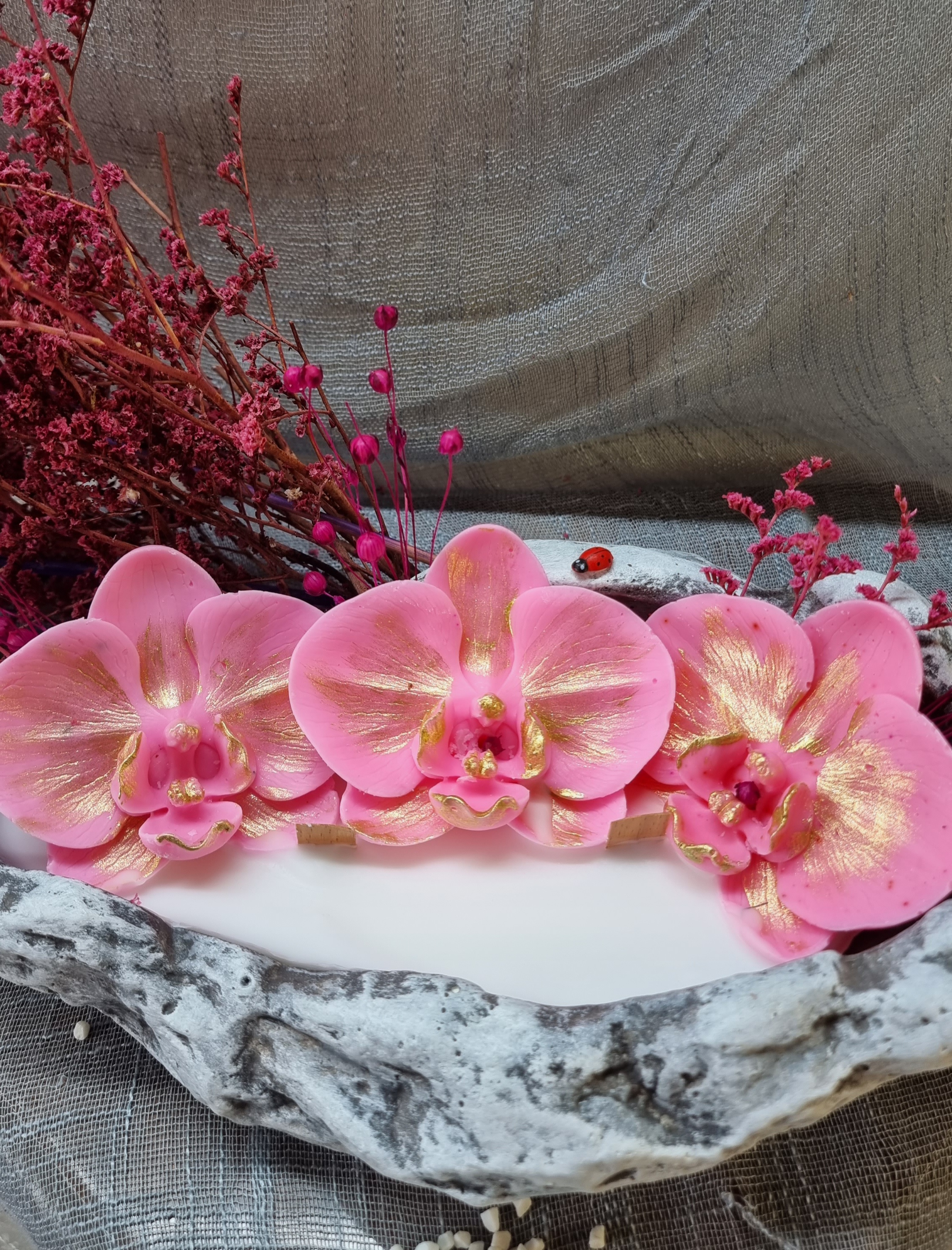 King-size candle with pink wax orchids