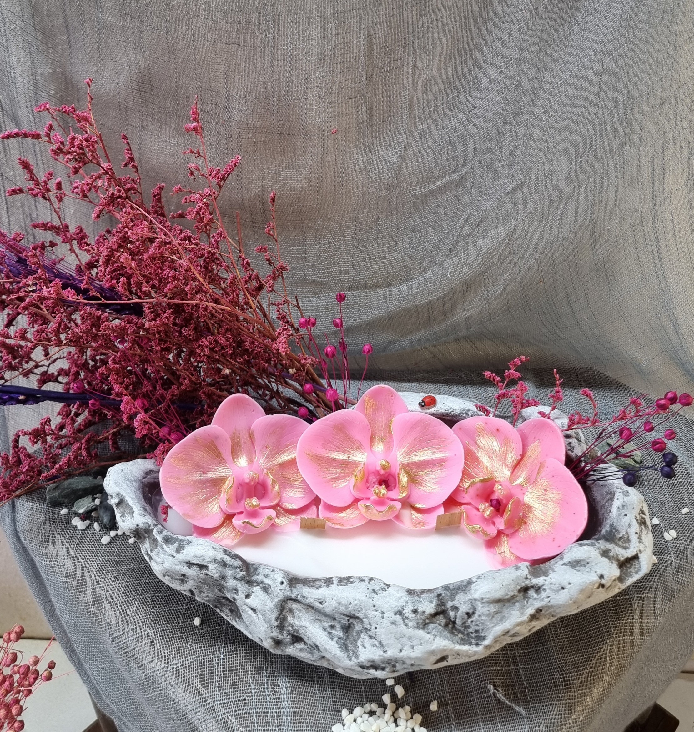 King-size candle with pink wax orchids 