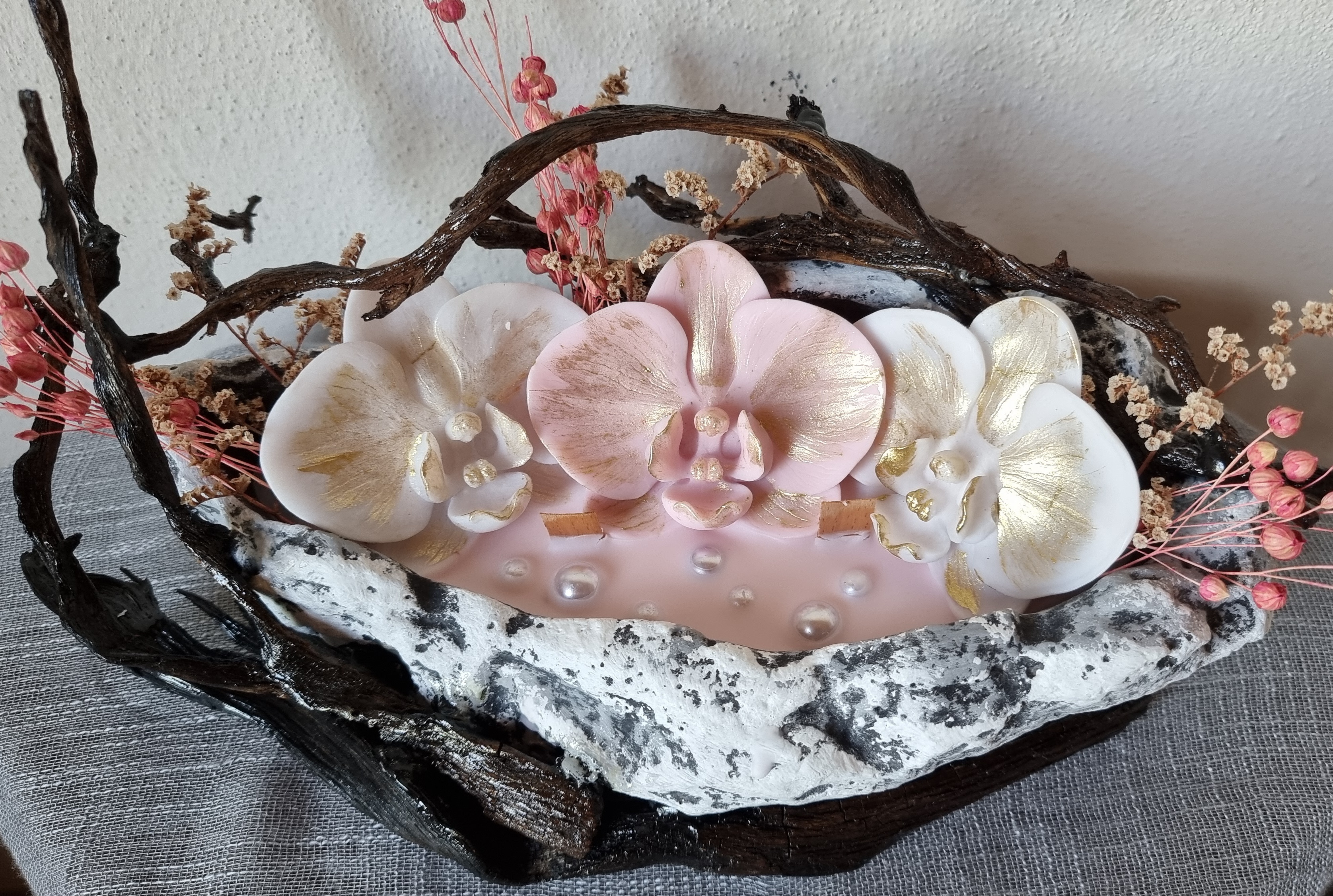 King-size candle with white and pink wax orchids 