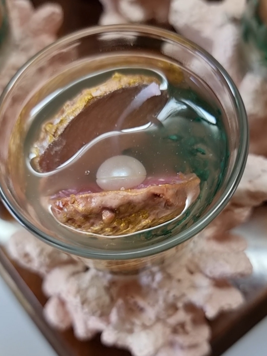 Transparent candle in a glass on top of a coral