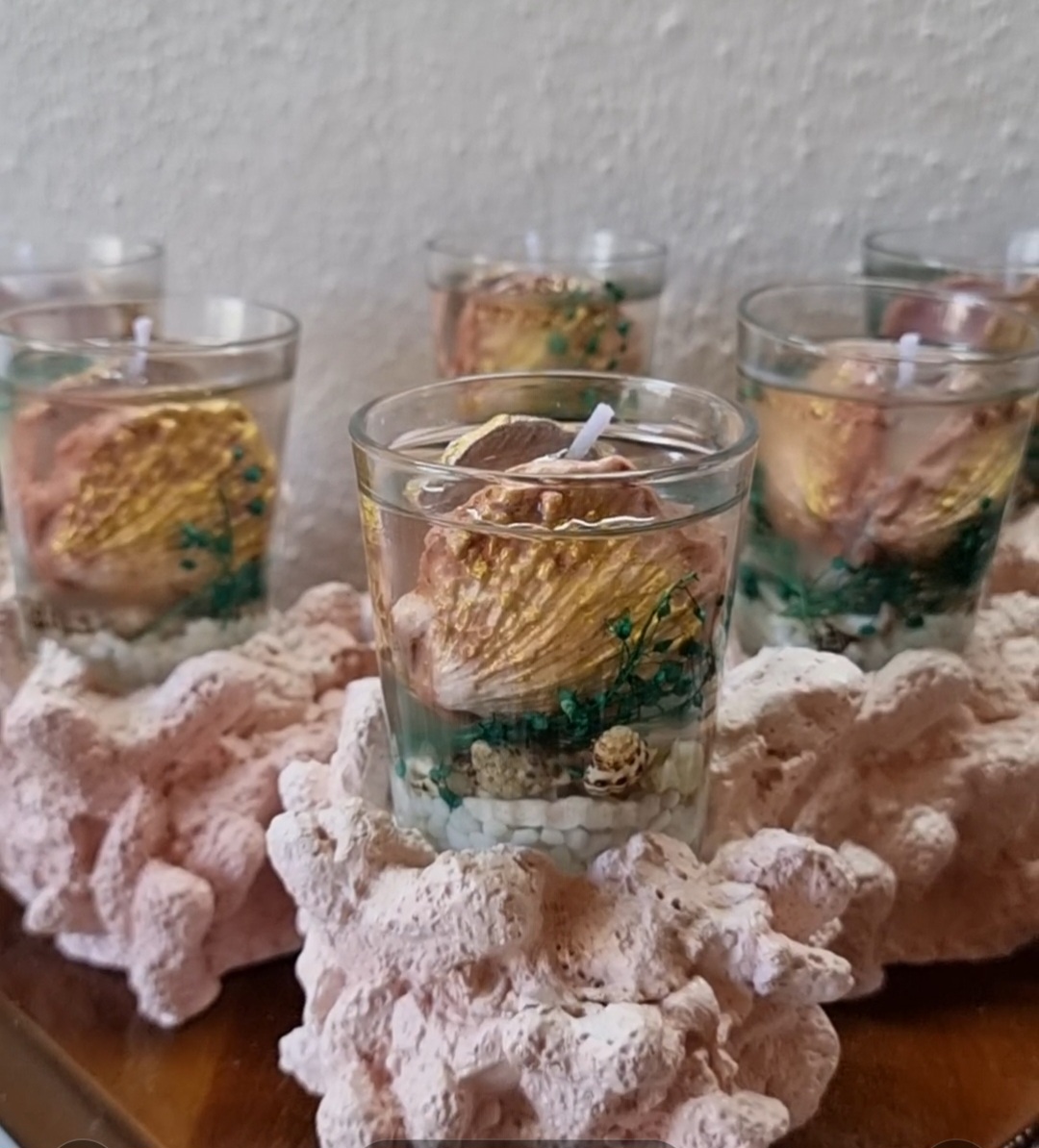 Transparent candle in a glass on top of a coral