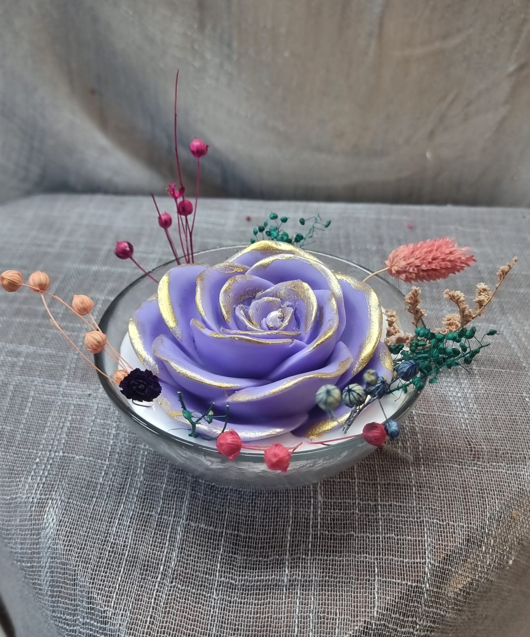 Scented wax rose in a glass bowl 