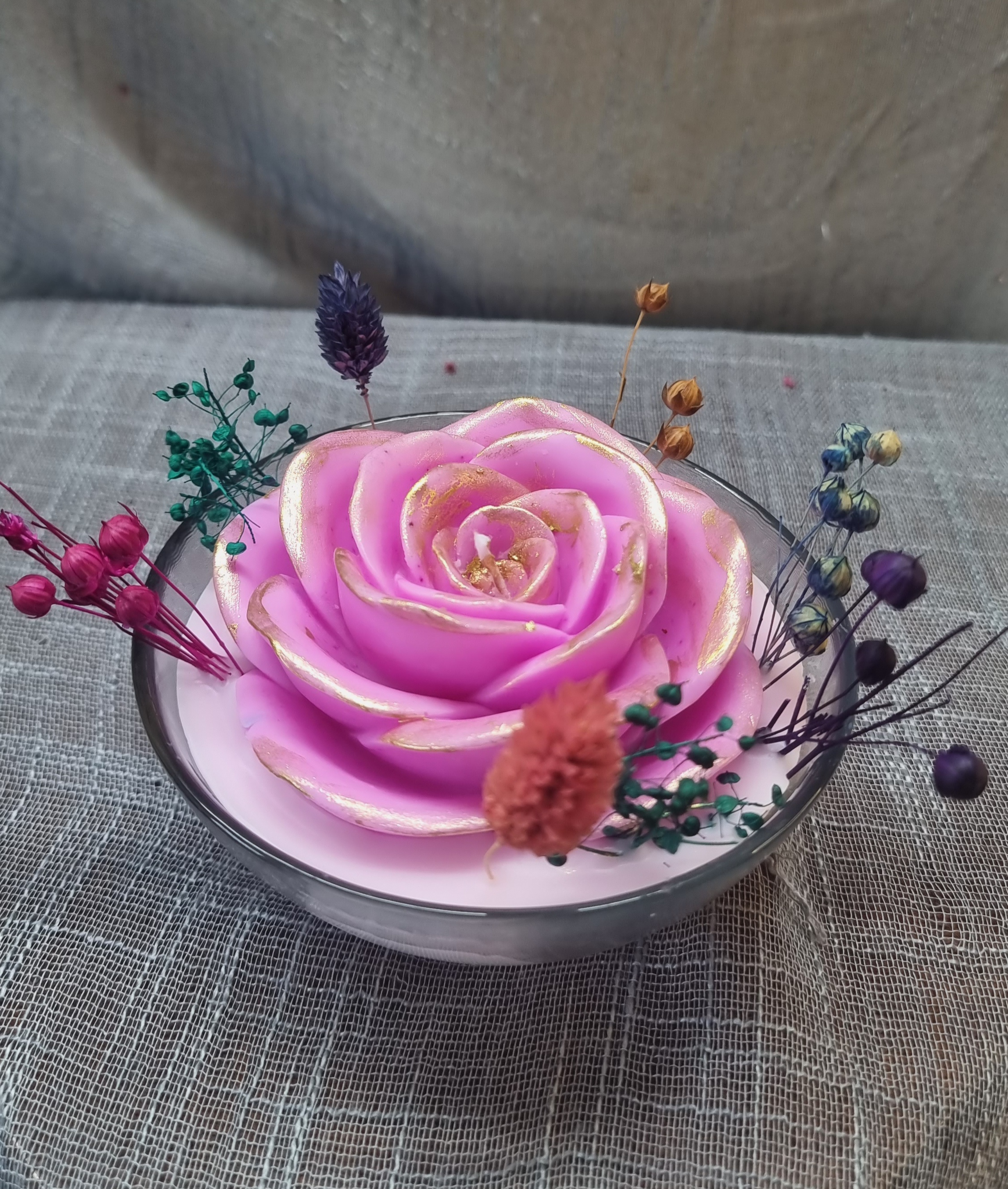 Scented wax rose in a glass bowl 