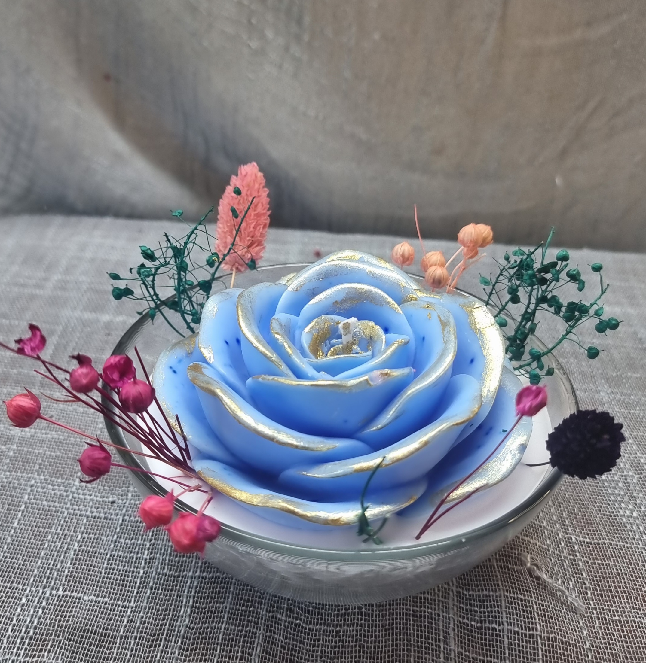 Scented wax rose in a glass bowl 
