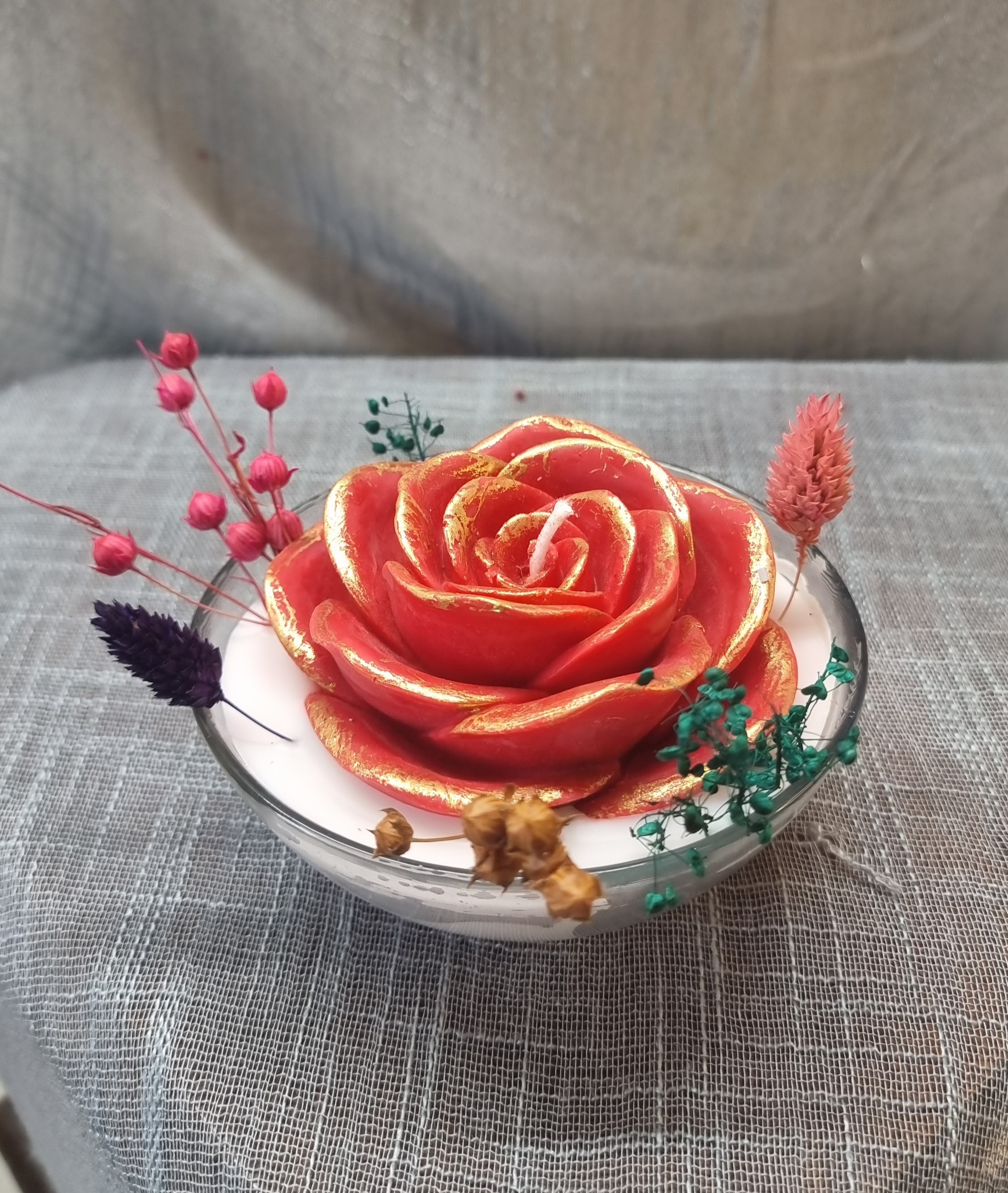 Scented wax rose in a glass bowl