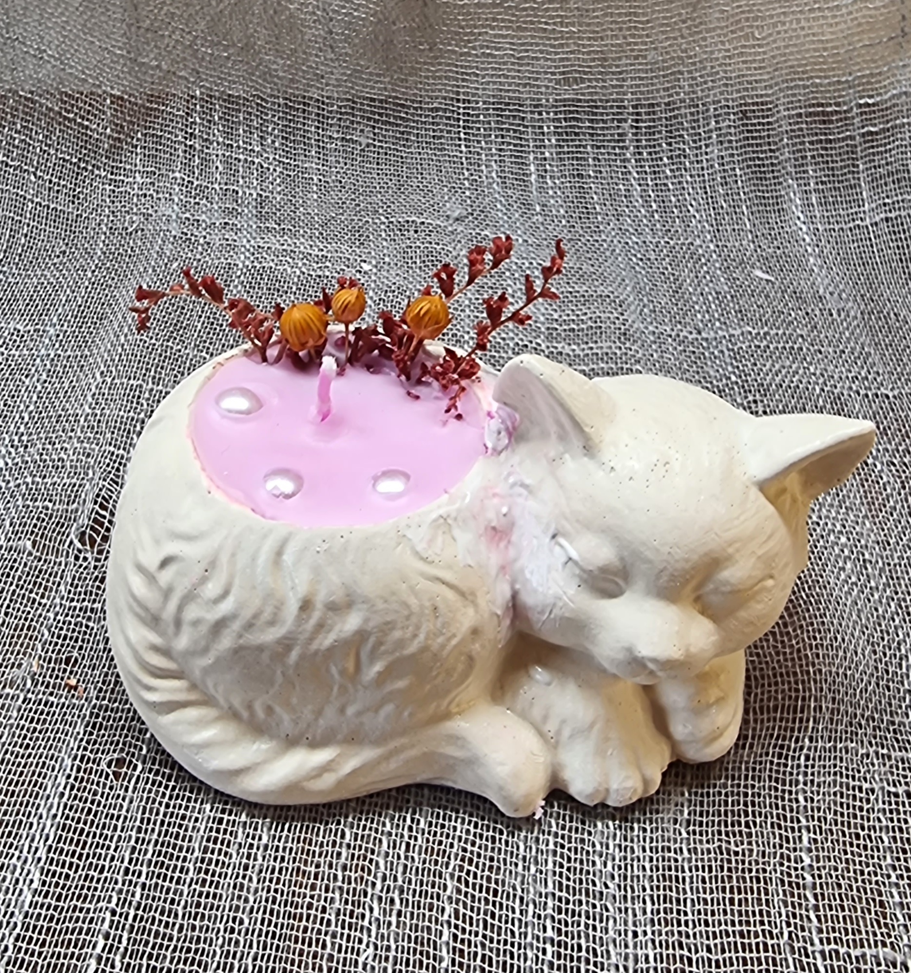 Pink candle in a cat-shaped container (mora-mora scented)