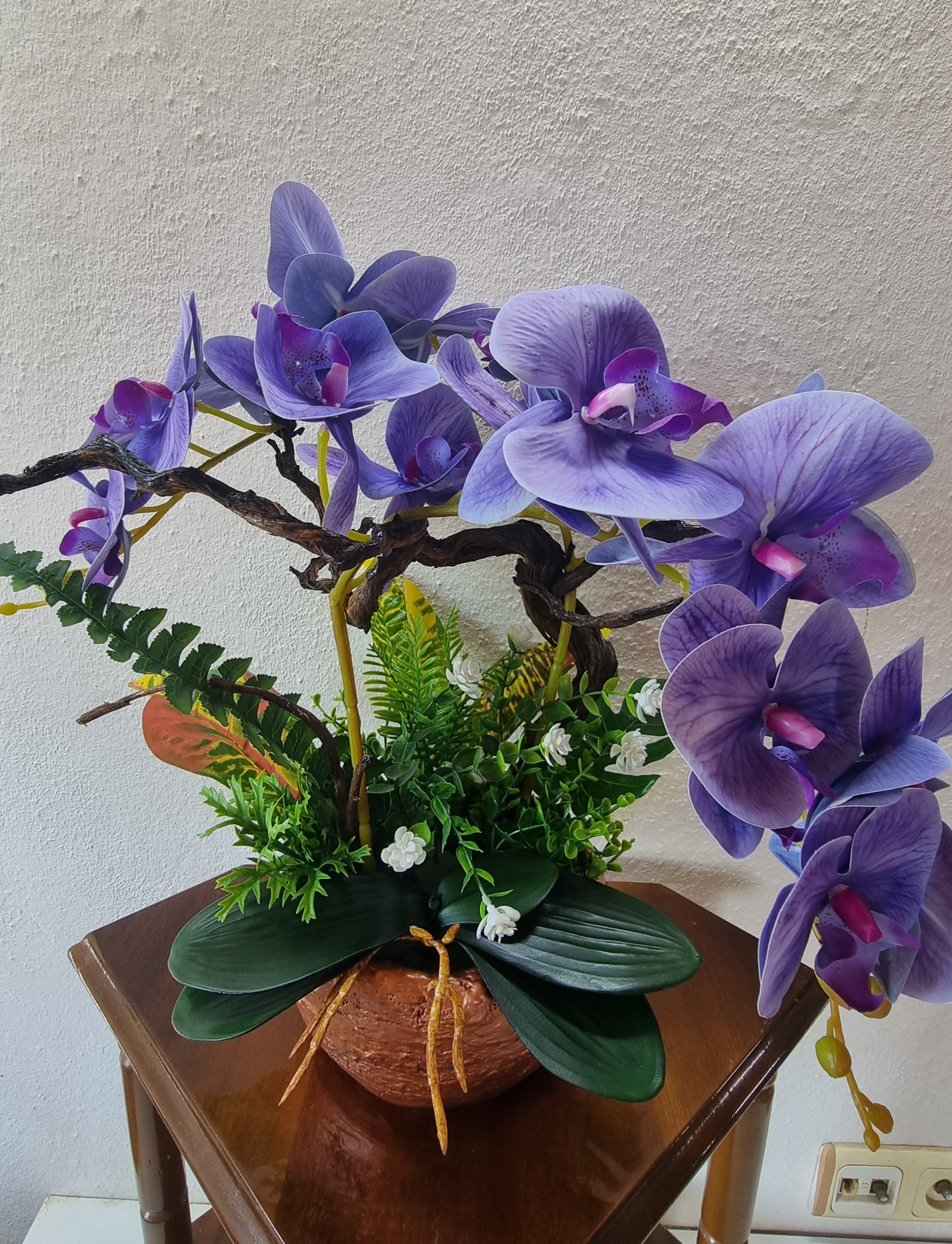 Planter with artificial dark-blue orchids