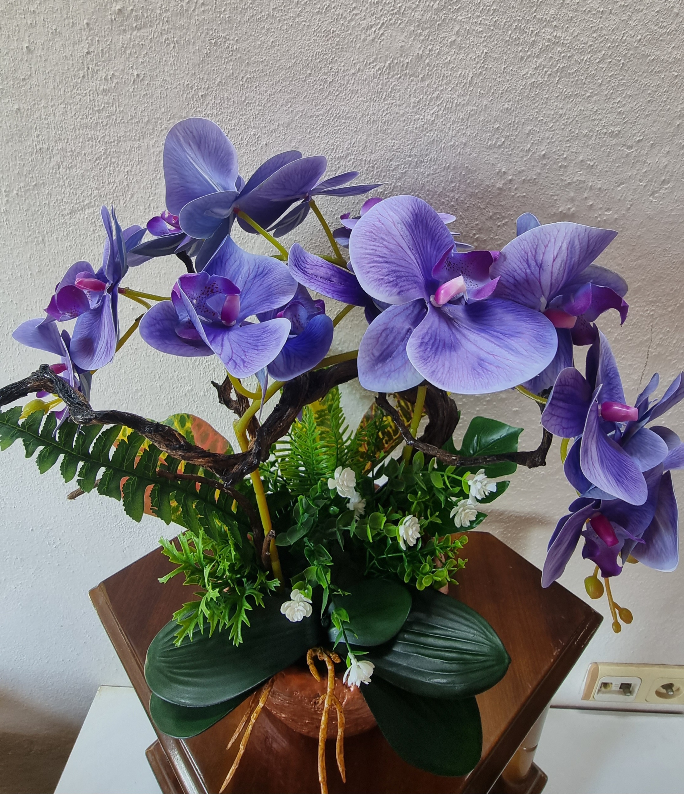 Planter with artificial dark-blue orchids 