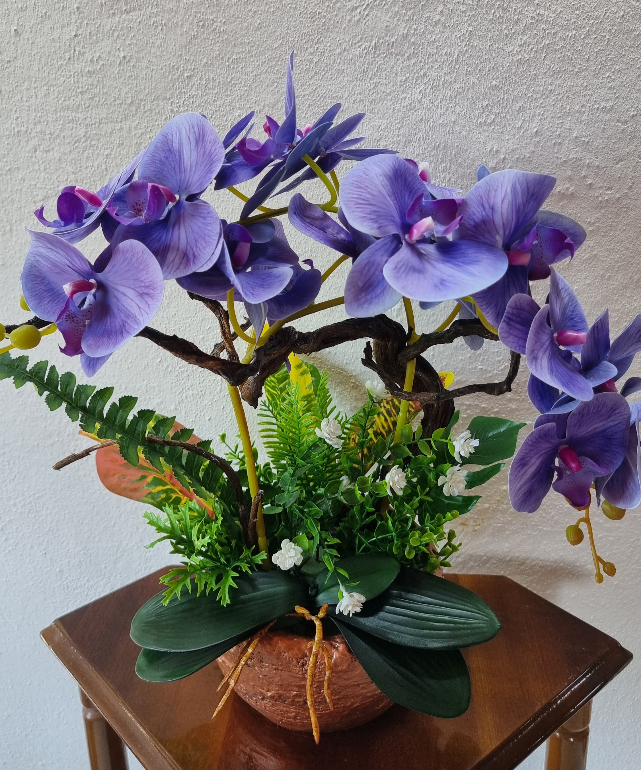 Planter with artificial dark-blue orchids 