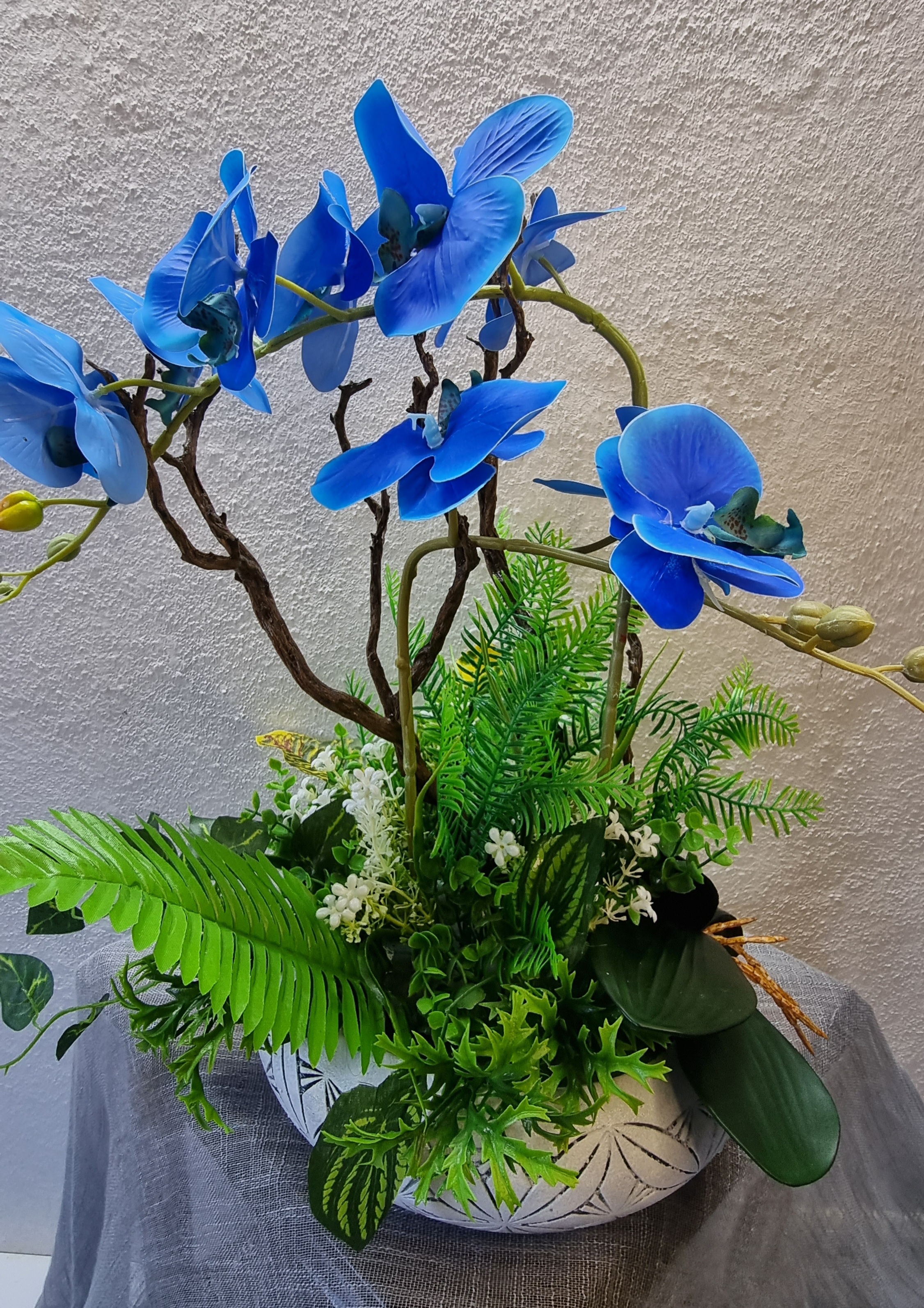 Normal-size white planter with artificial blue orchids 