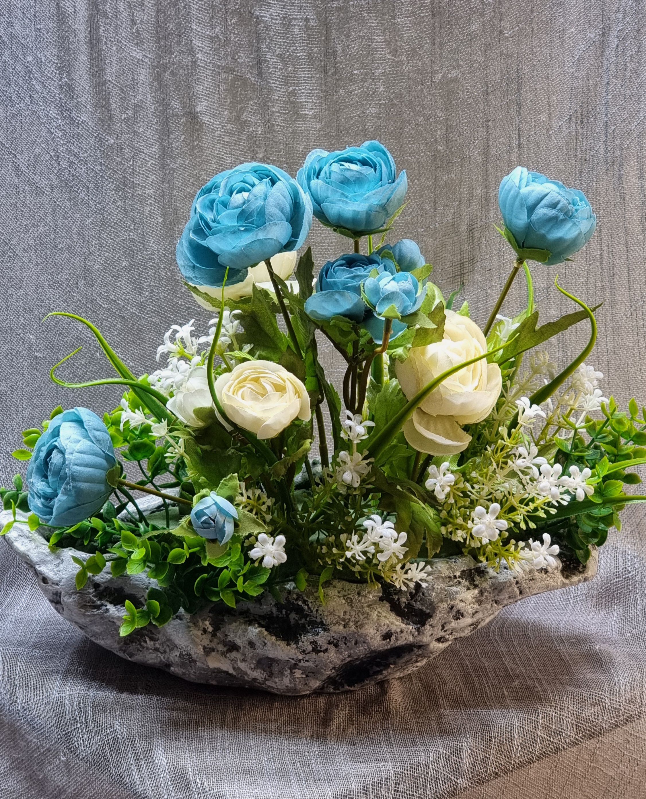 Planter arrangement with artificial turquoise and cream roses