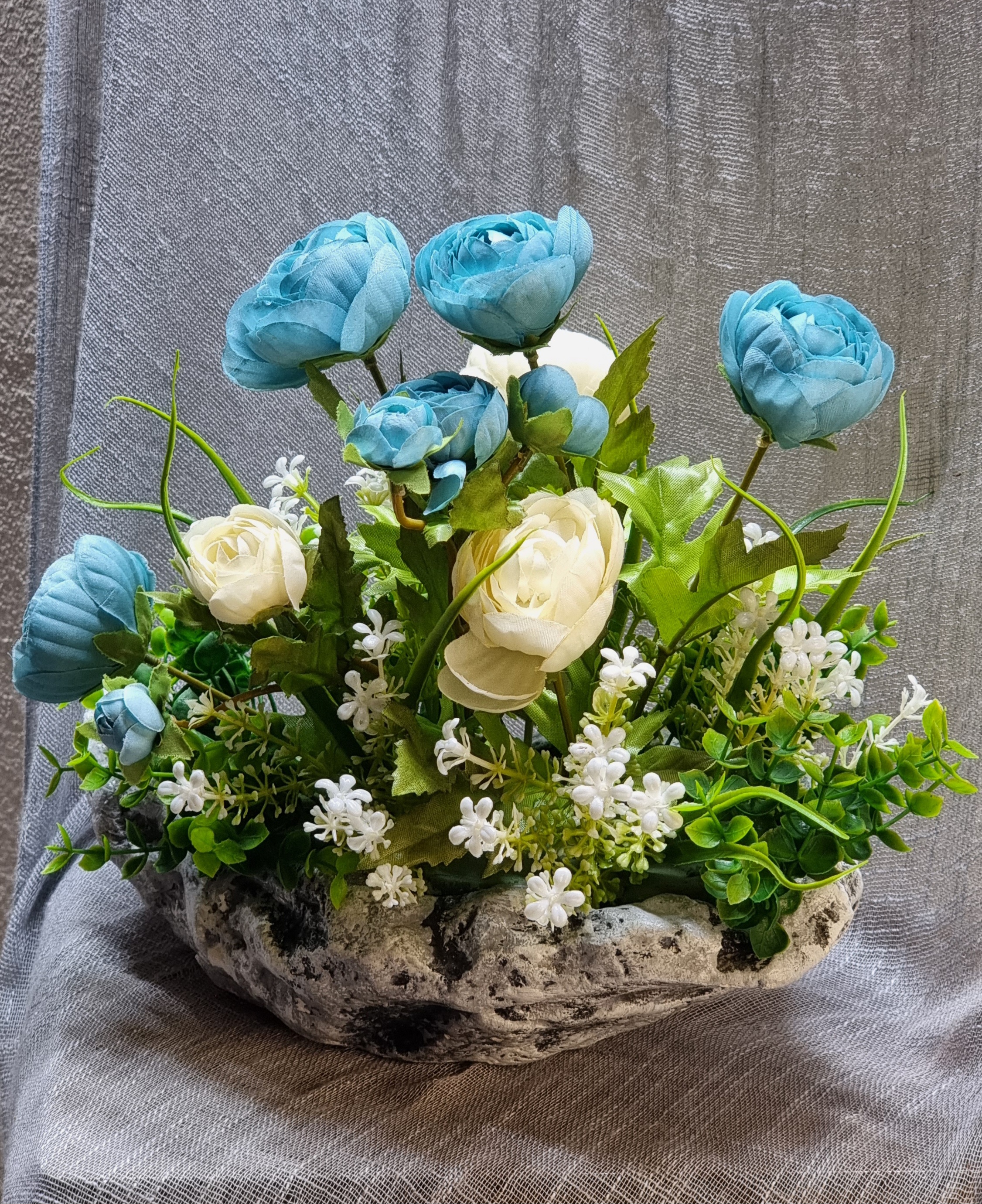 Planter arrangement with artificial turquoise and cream roses