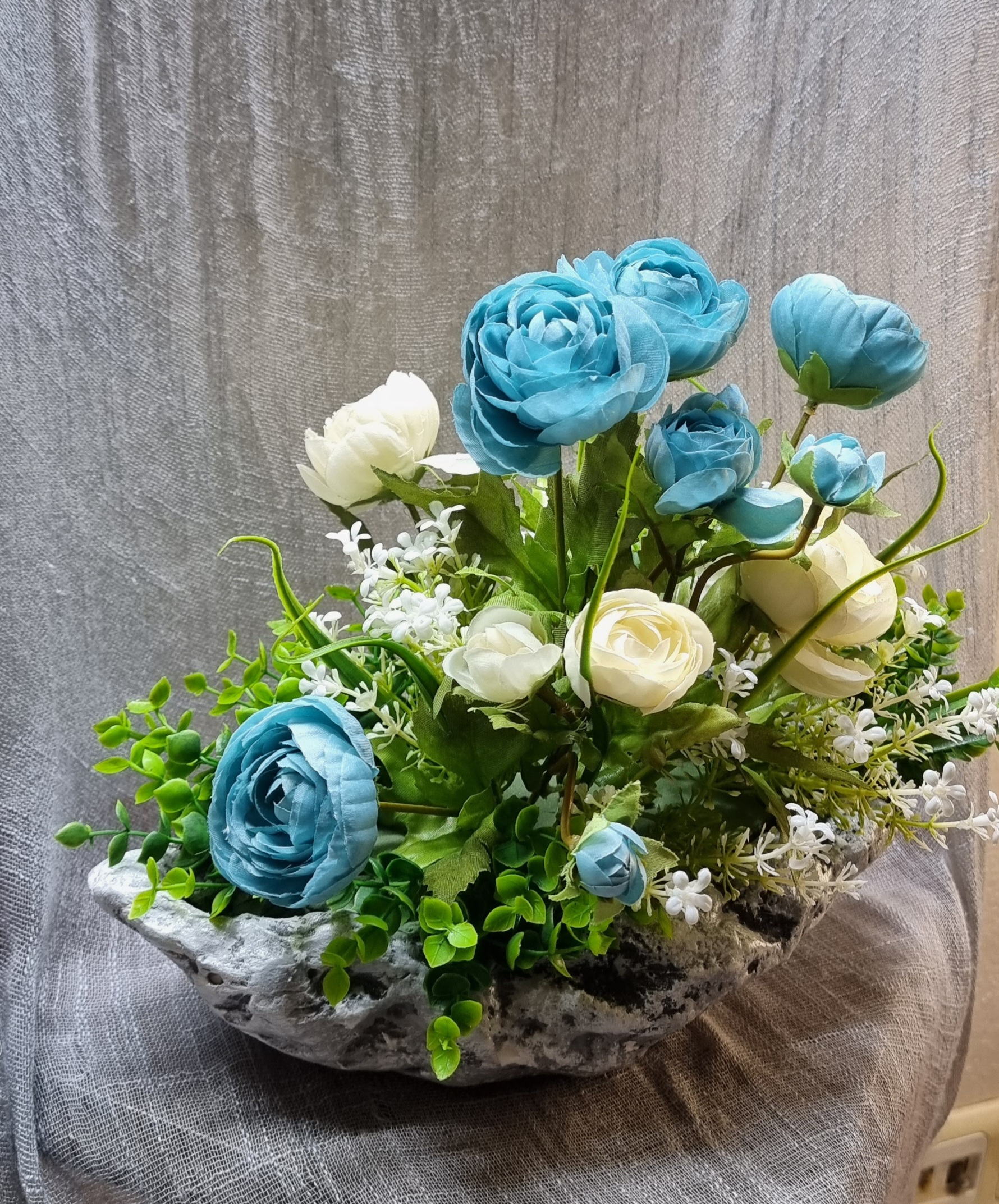 Planter arrangement with artificial turquoise and cream roses