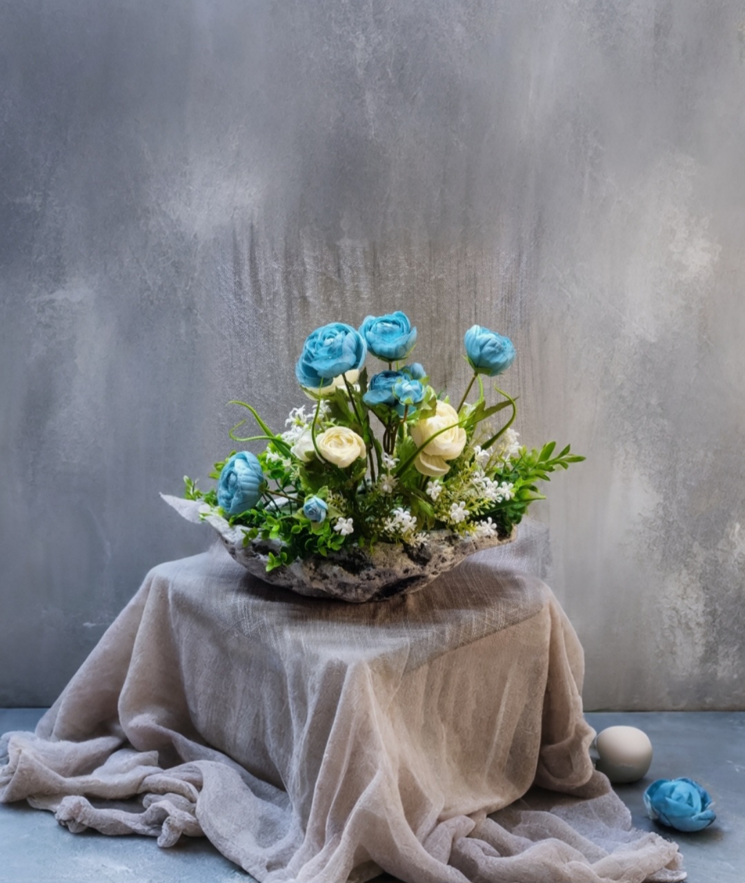 Planter arrangement with artificial turquoise and cream roses