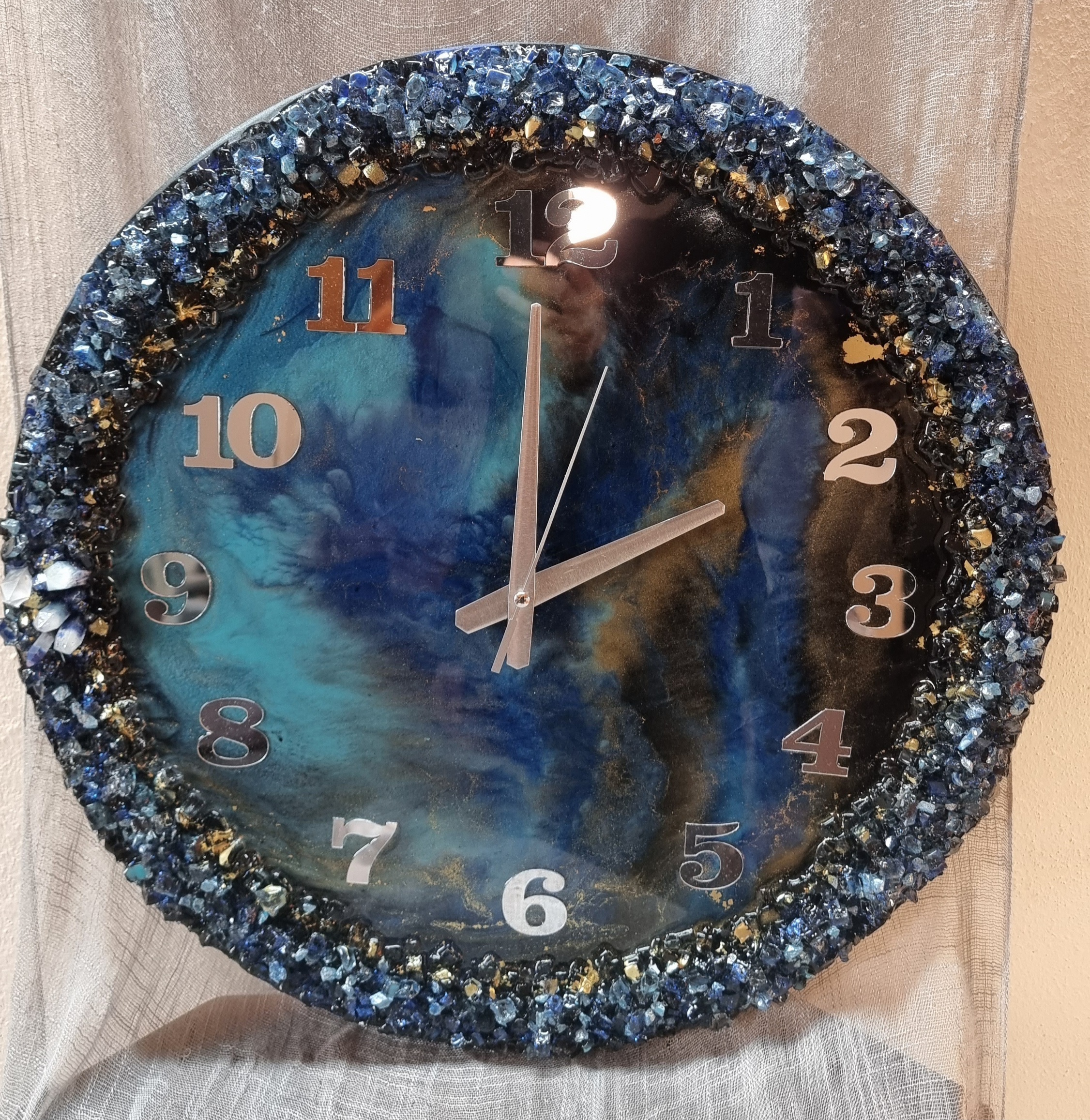 Dark-blue-and-turquoise epoxy-resin coated clock featuring Arabic numbers. Size (diameter) ranges from 14 to 23,8 inches.