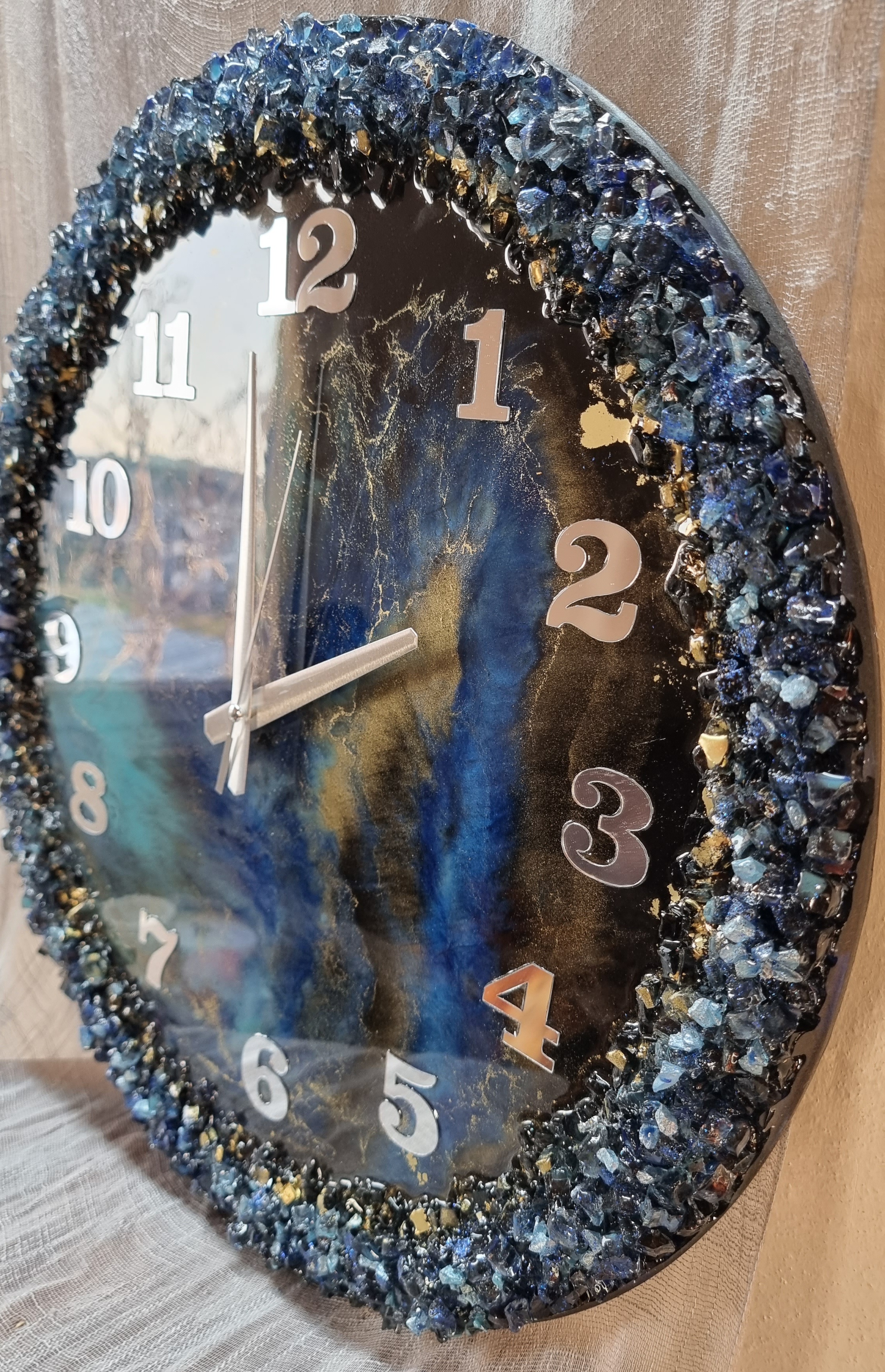 Dark-blue-and-turquoise epoxy-resin coated clock featuring Arabic numbers. Size (diameter) ranges from 14 to 23,8 inches. 