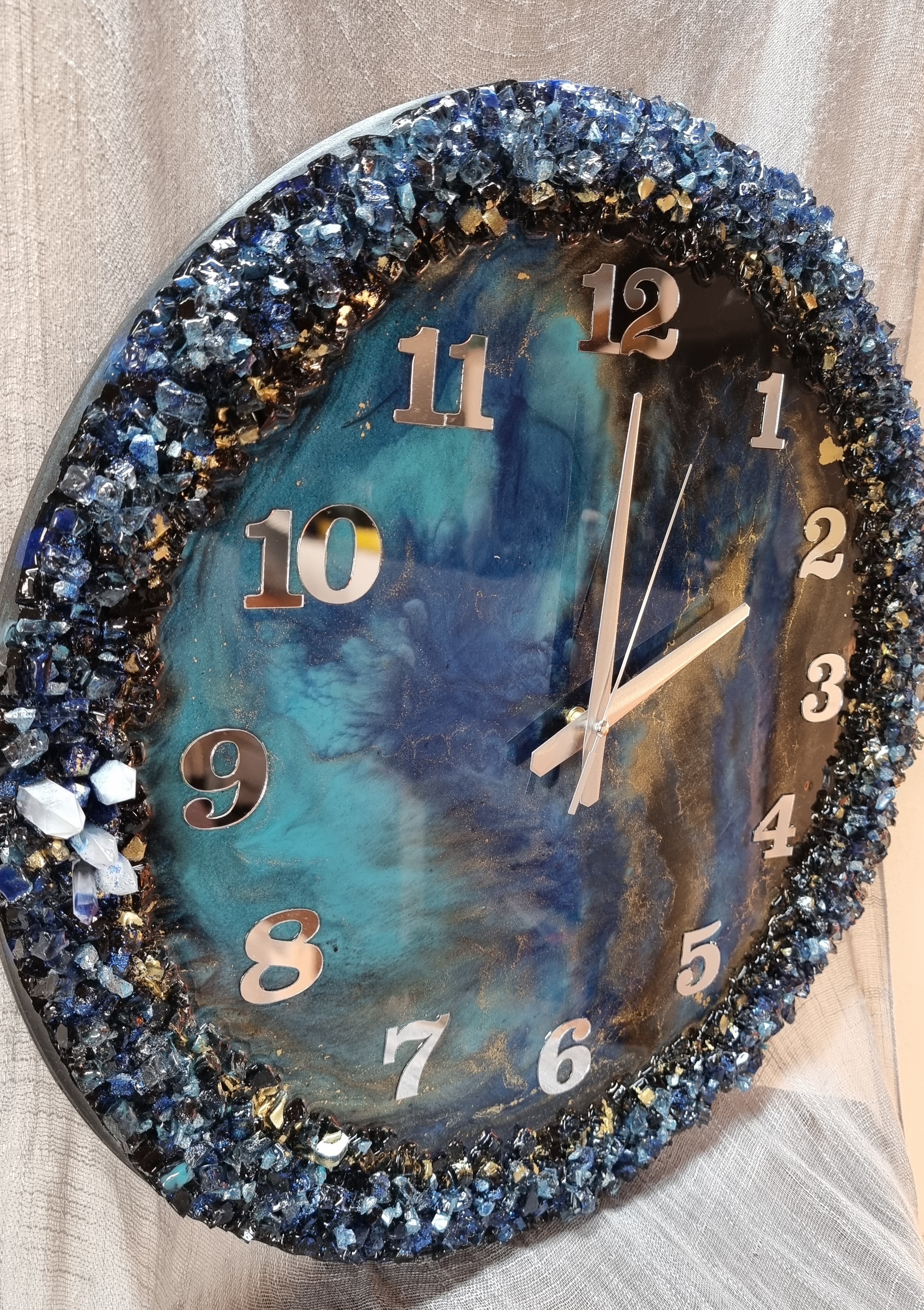 Dark-blue-and-turquoise epoxy-resin coated clock featuring Arabic numbers. Size (diameter) ranges from 14 to 23,8 inches. 