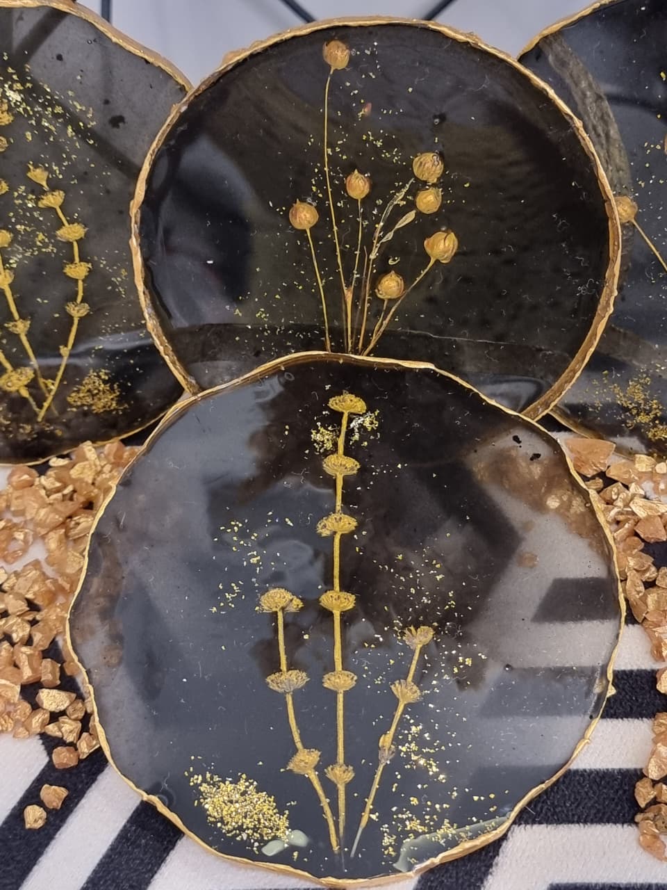 Epoxy-resin coasters in black colour featuring golden flowers