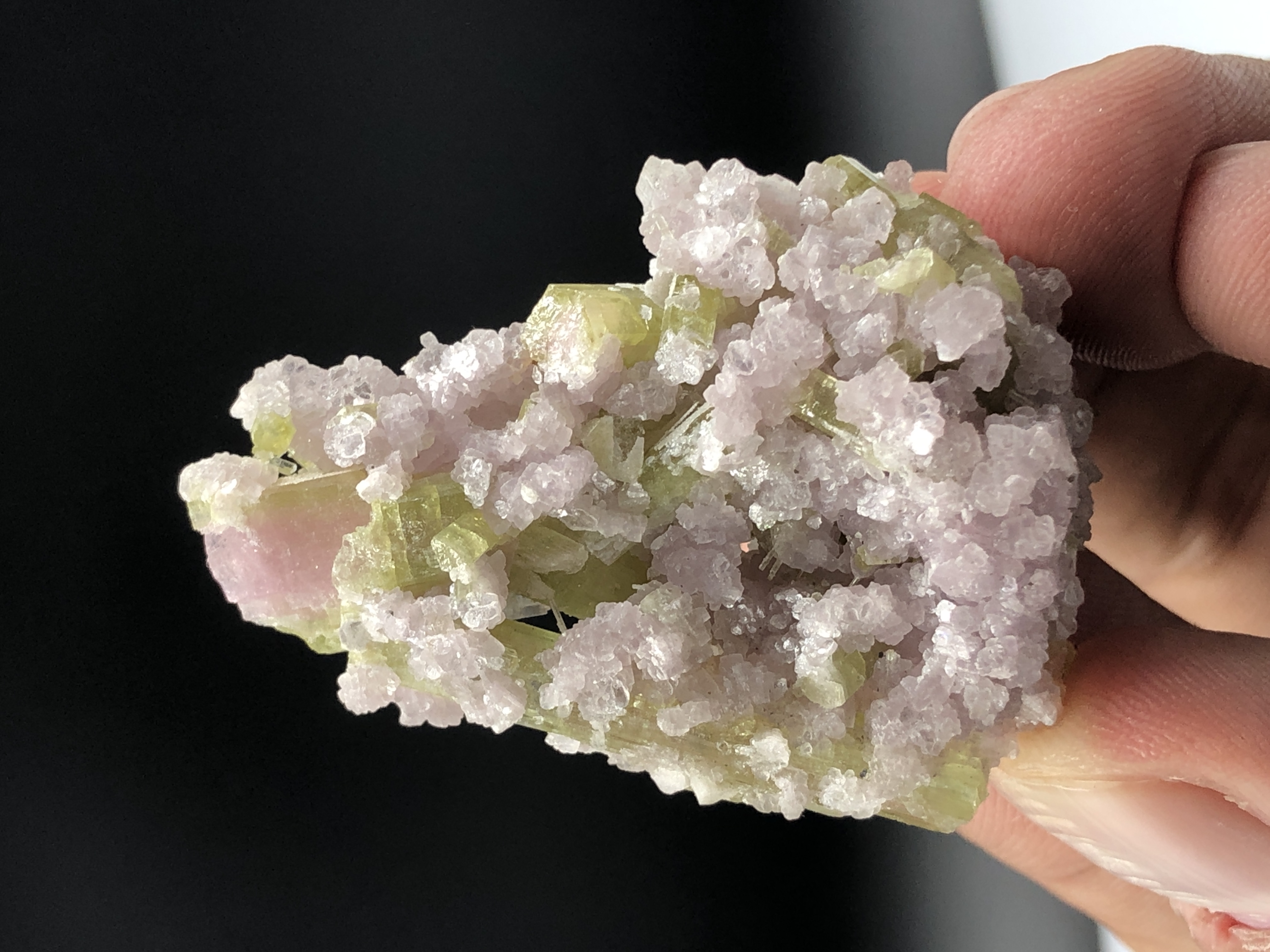 An Aesthetic Tourmaline Crystal Nestled on Lepidolite Mica.