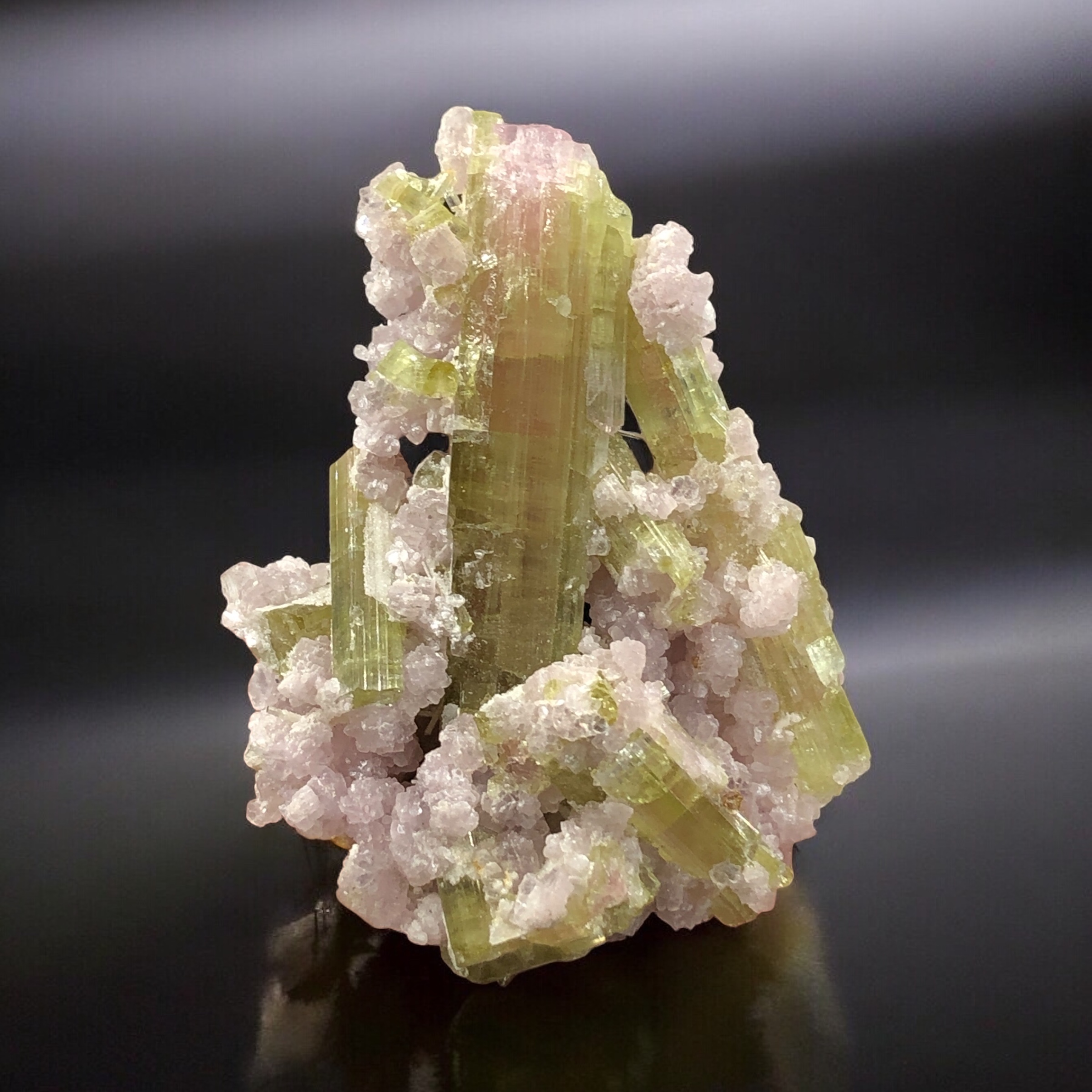 An Aesthetic Tourmaline Crystal Nestled on Lepidolite Mica.