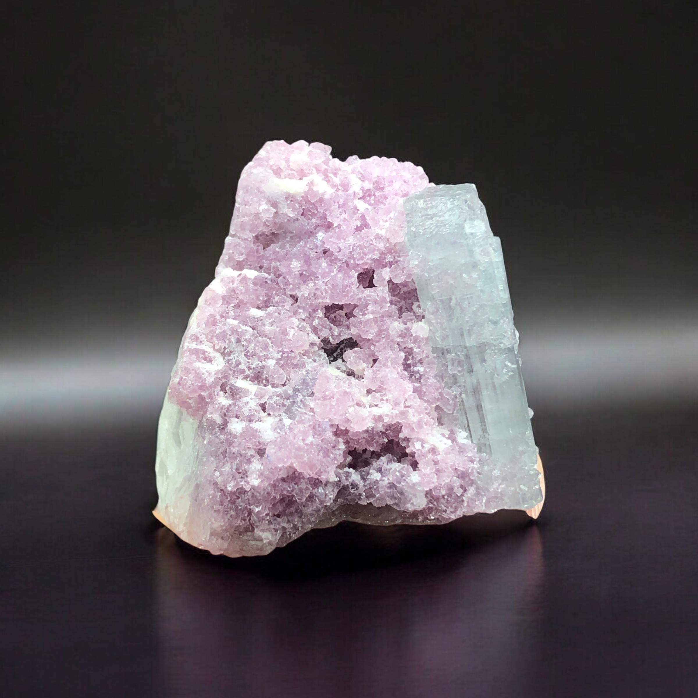 Natural Tourmaline Crystal Rested on Lepidolite. 