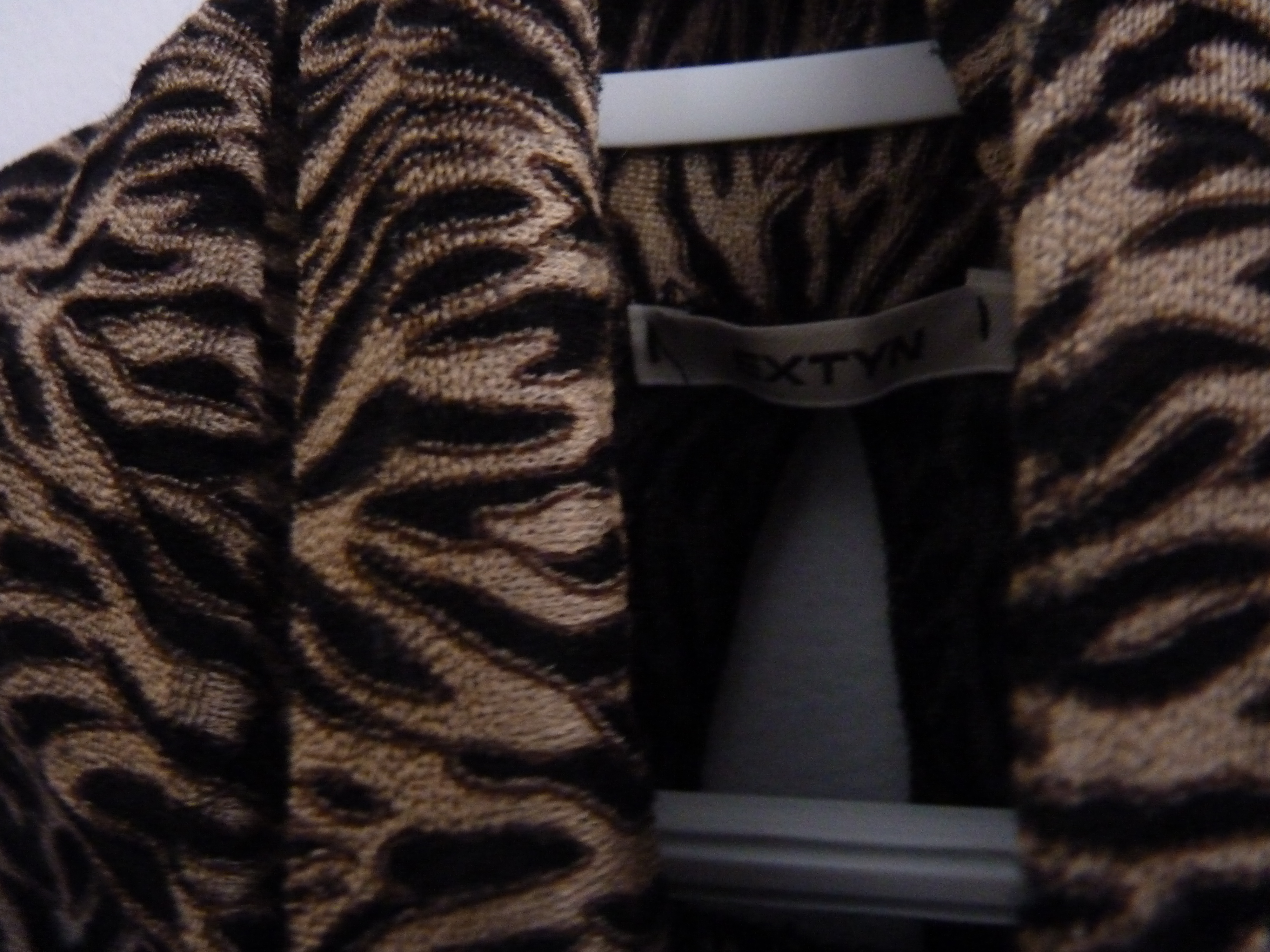 Versatile sleeveless turtleneck animal print top