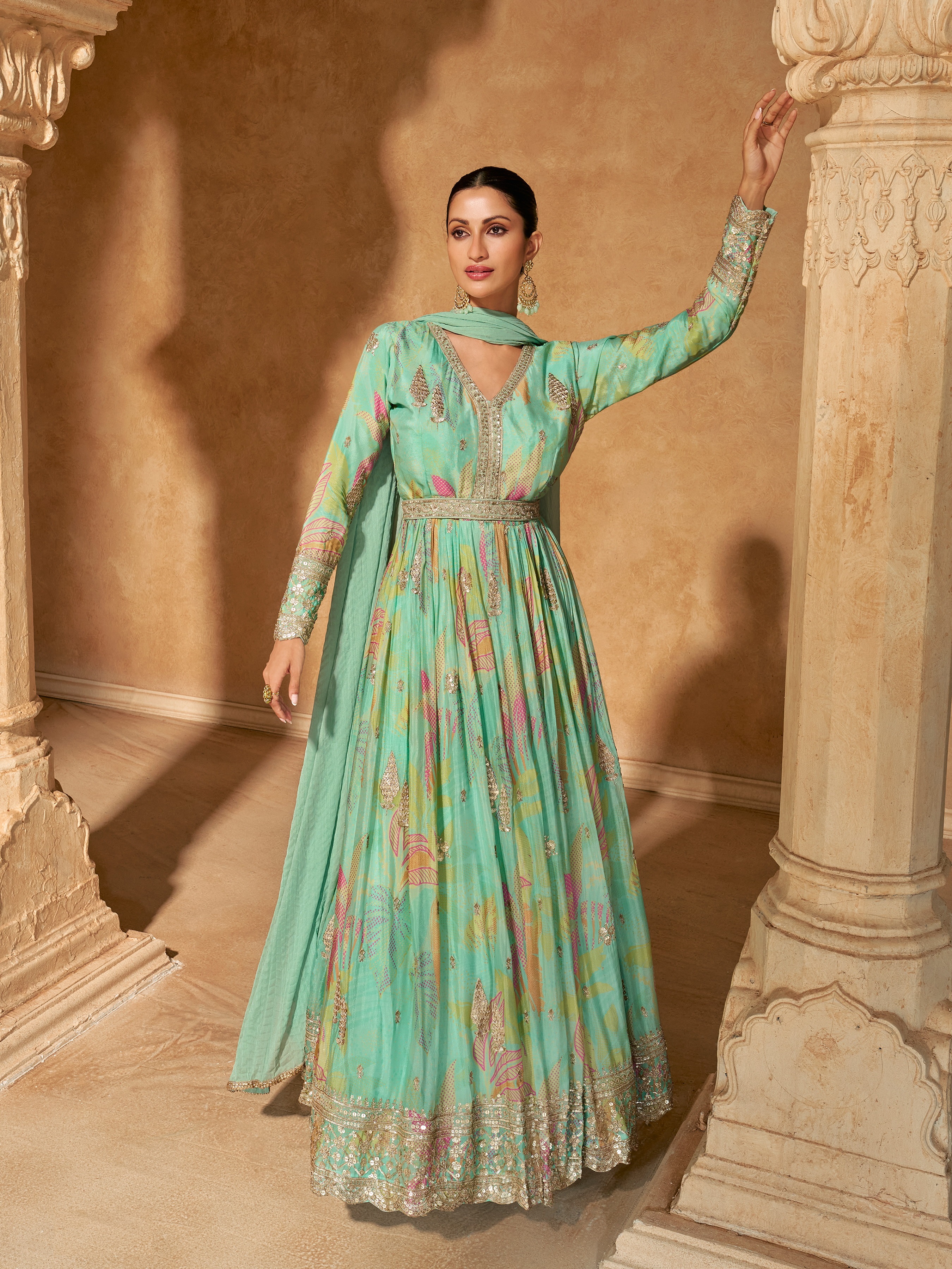 Celebrate the joy of Eid in style with this captivating gown, adorned with sequinned embroidery and a delicate digital floral print on luxurious teal georgette fabric.