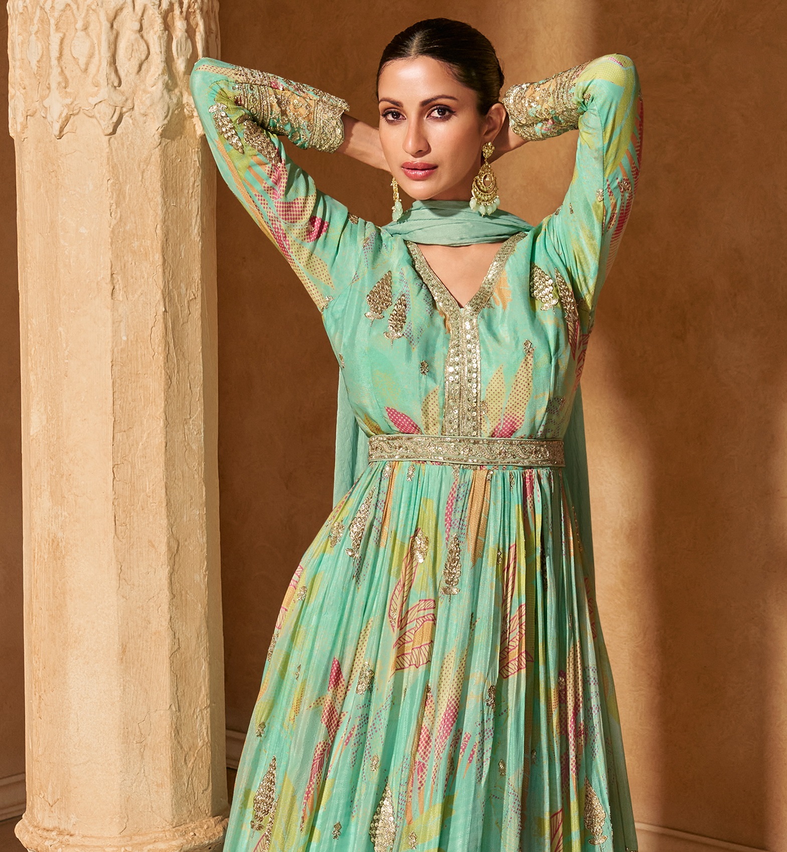 Celebrate the joy of Eid in style with this captivating gown, adorned with sequinned embroidery and a delicate digital floral print on luxurious teal georgette fabric.