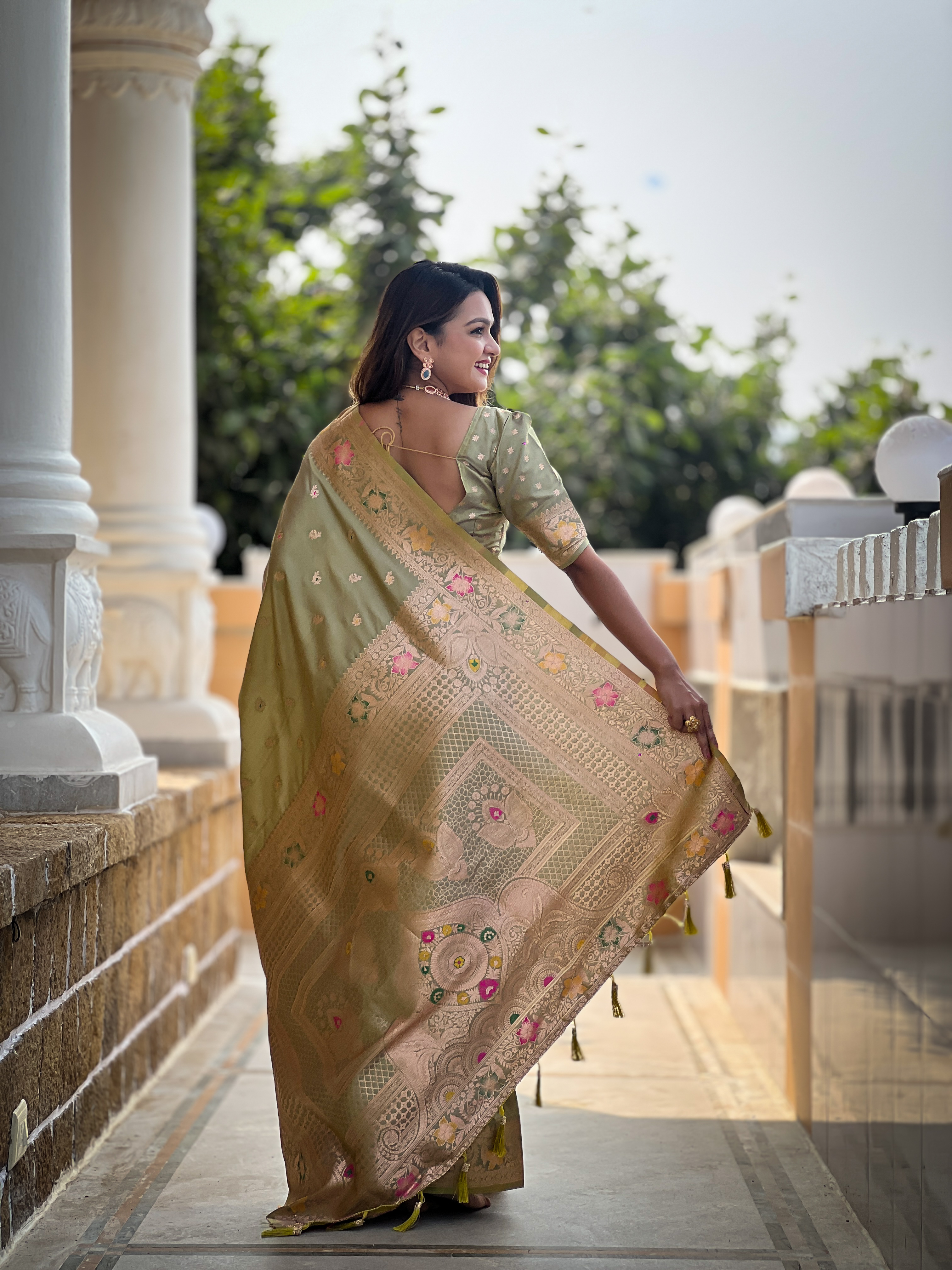 Adorn yourself in the beauty of this mehendi green Banarasi silk saree