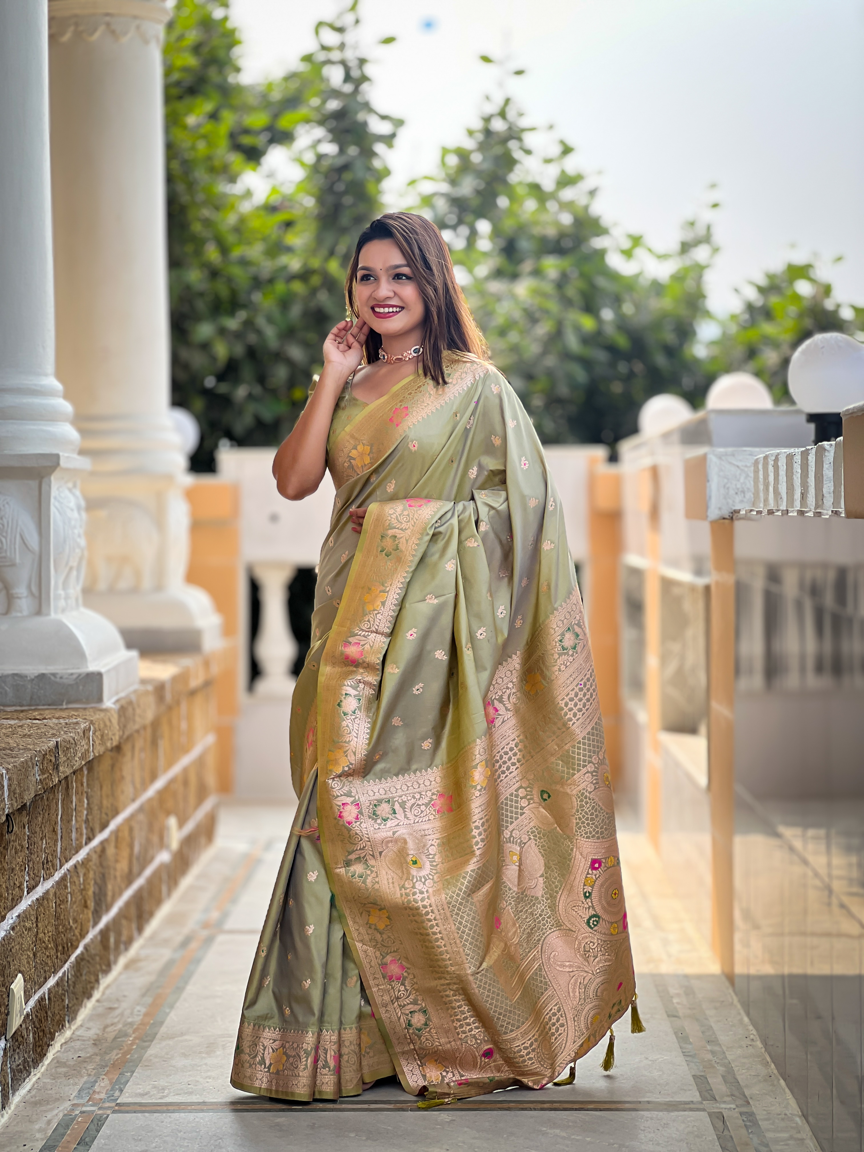 Adorn yourself in the beauty of this mehendi green Banarasi silk saree