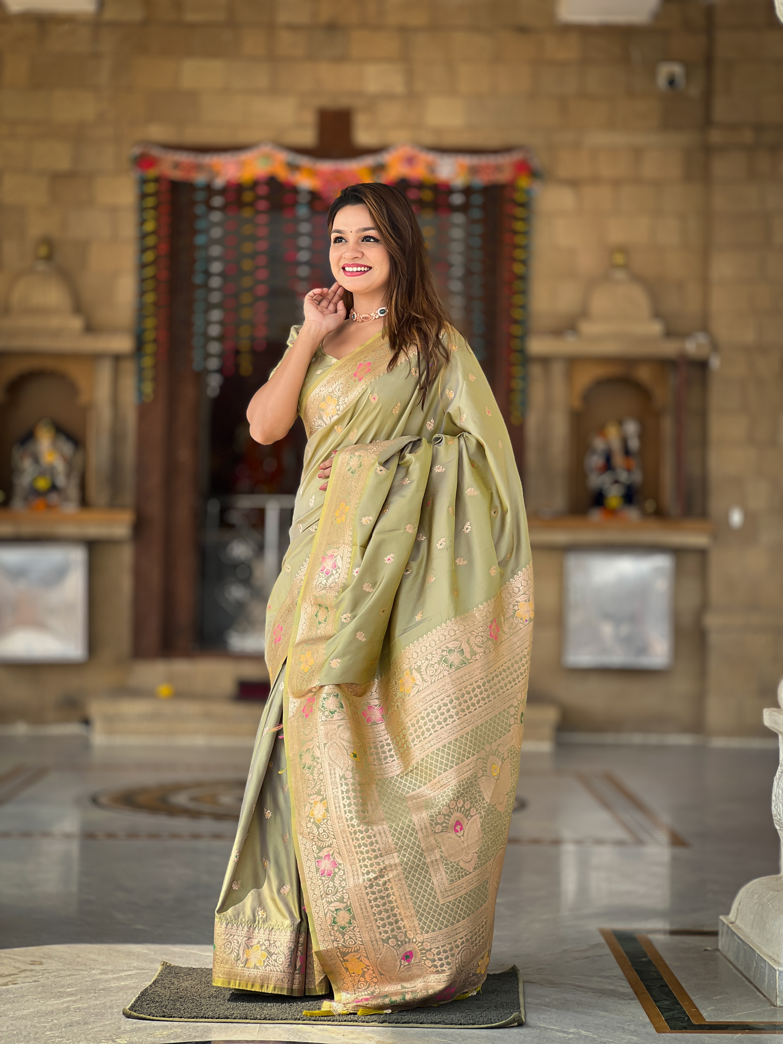Adorn yourself in the beauty of this mehendi green Banarasi silk saree