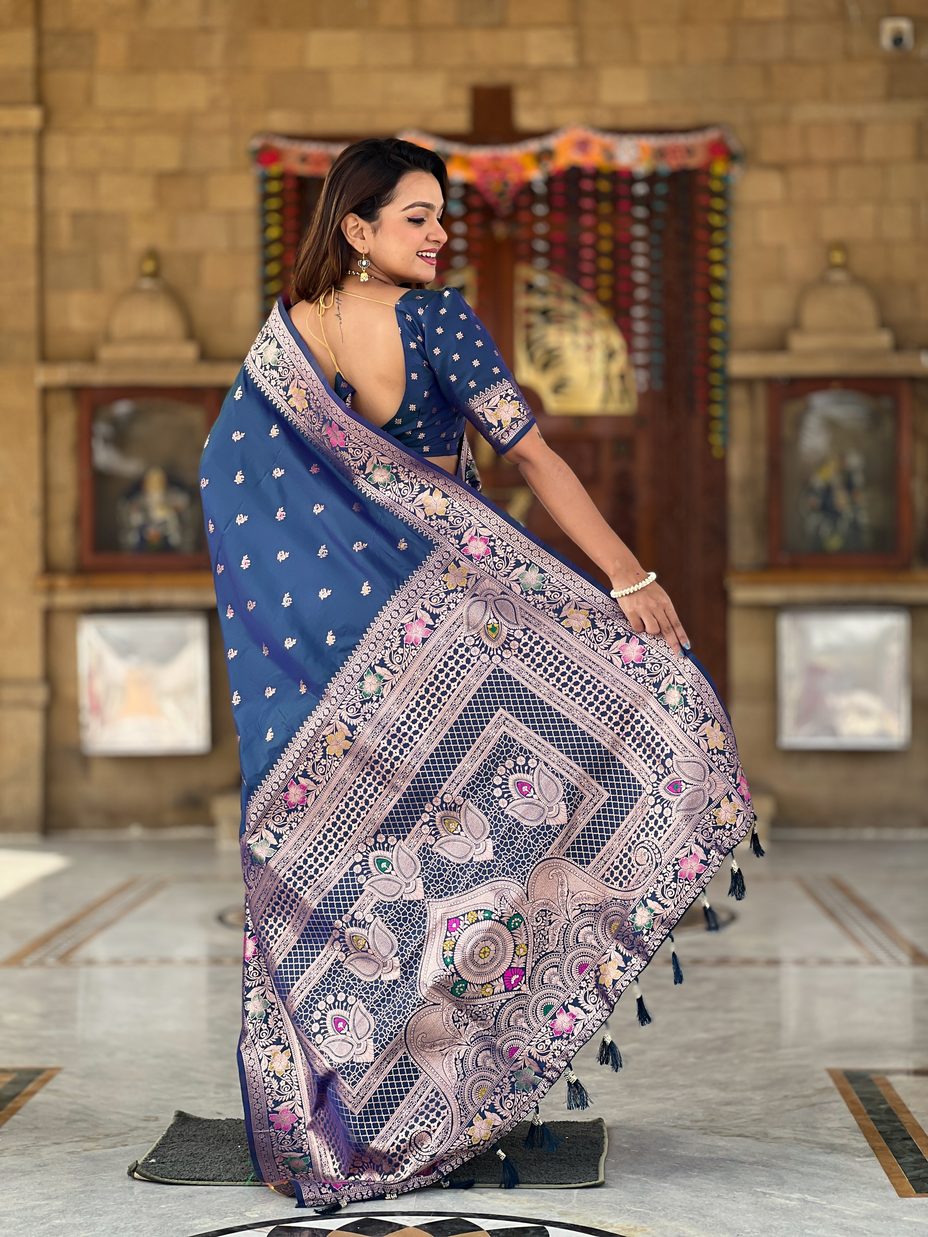 Drape yourself in the captivating beauty of this peacock blue Banarasi silk saree