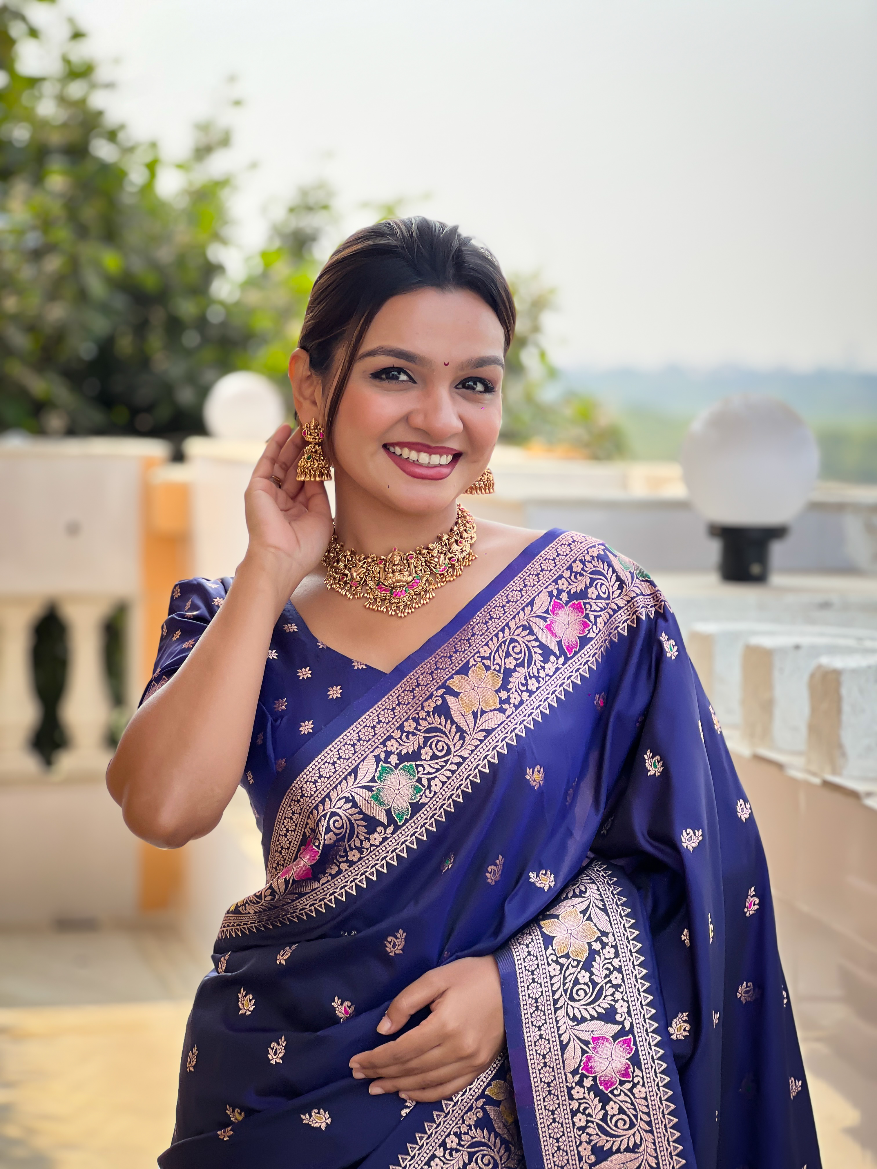 Grace yourself with the timeless beauty of this navy blue Banarasi silk saree